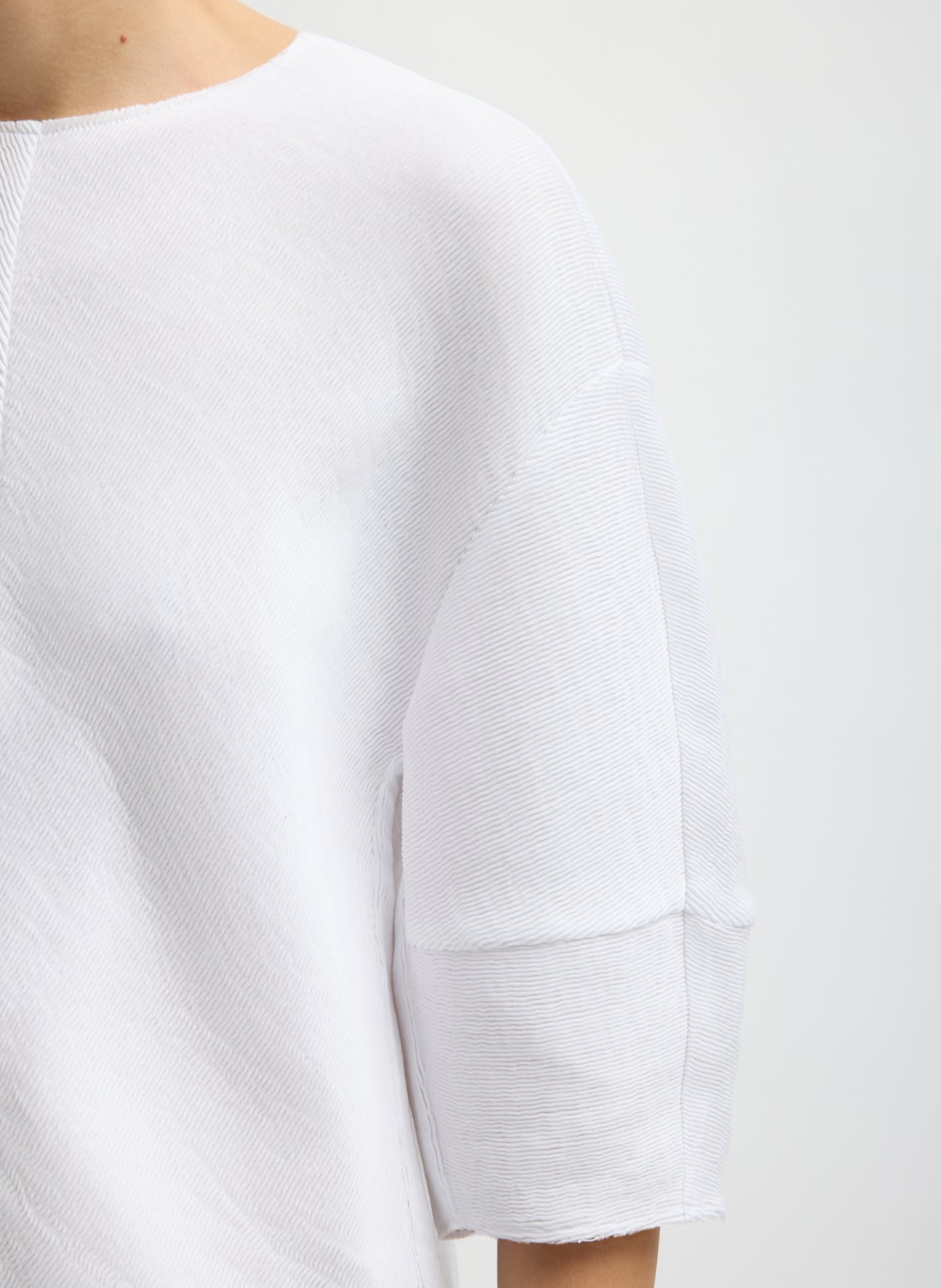 White Viscose Plisse Hinged Short Sleeve Top - closeup of plisse fabrication