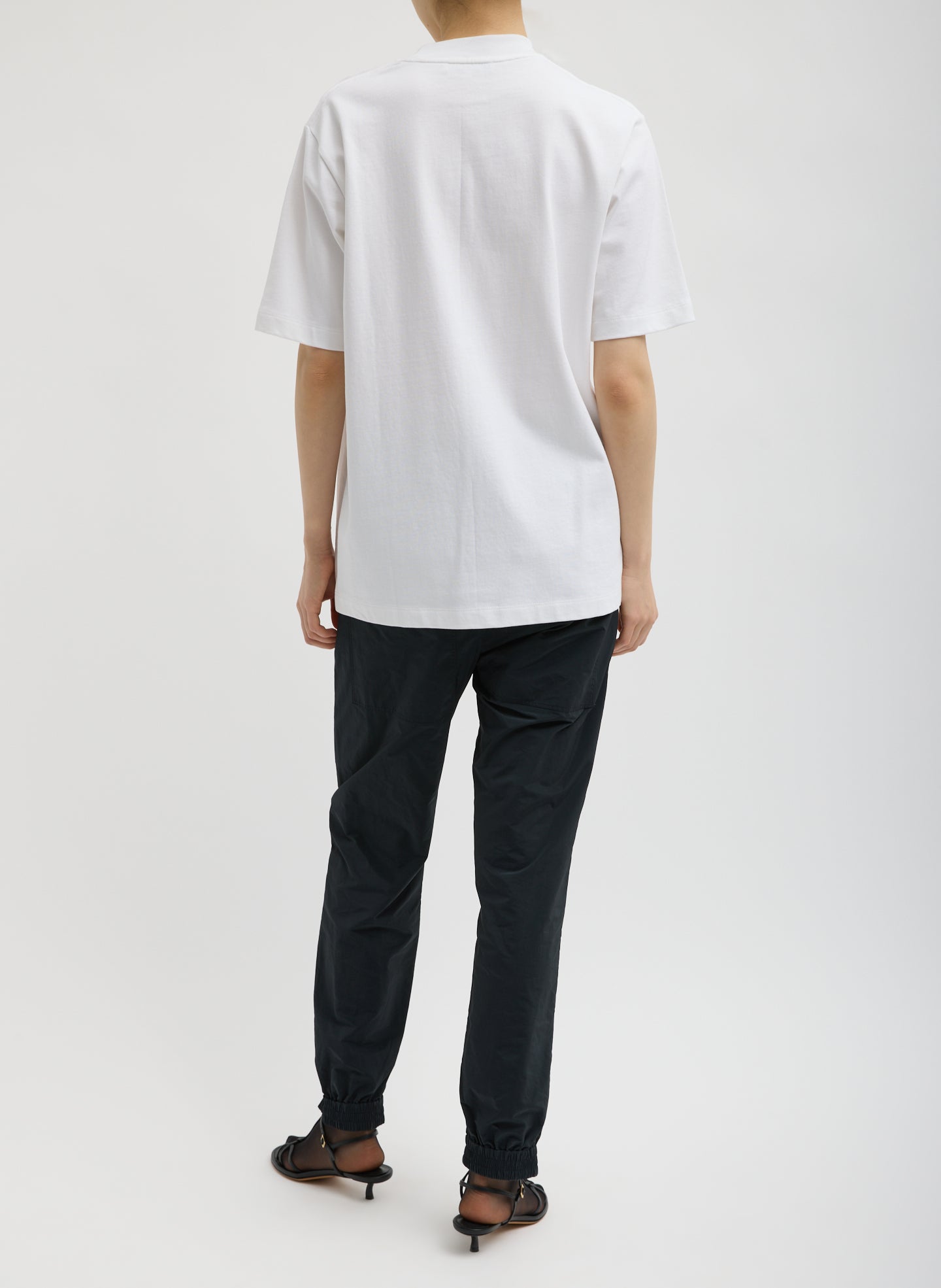 White Perfect Unisex T-Shirt "Untitled" - full look, back view on model