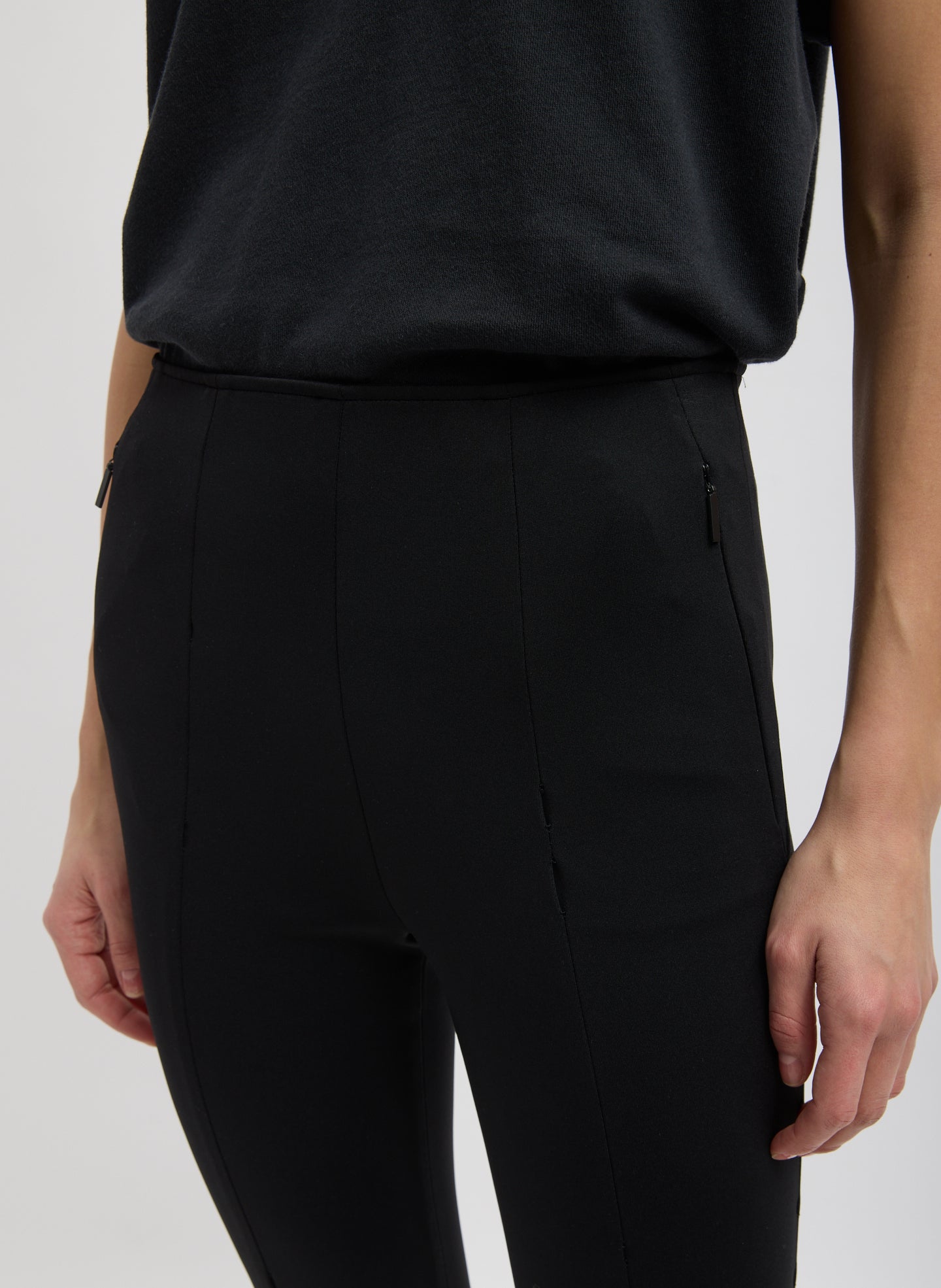 Black Compact Ultra Stretch Knit Stirrup Legging - closeup of waistband and side zip details
