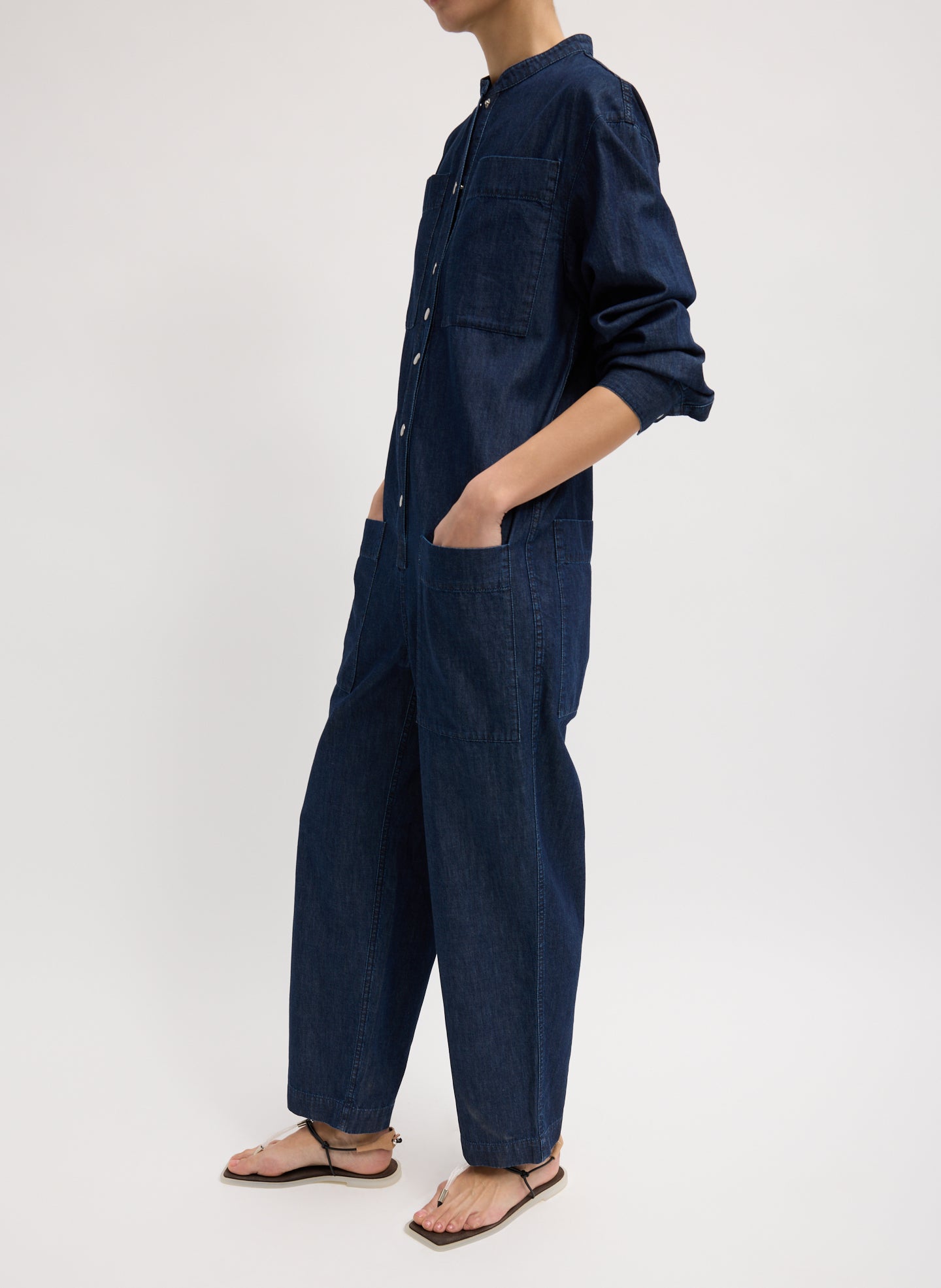 Dark Wash Summer Denim Jumpsuit - long sleeved, button up, side view on model