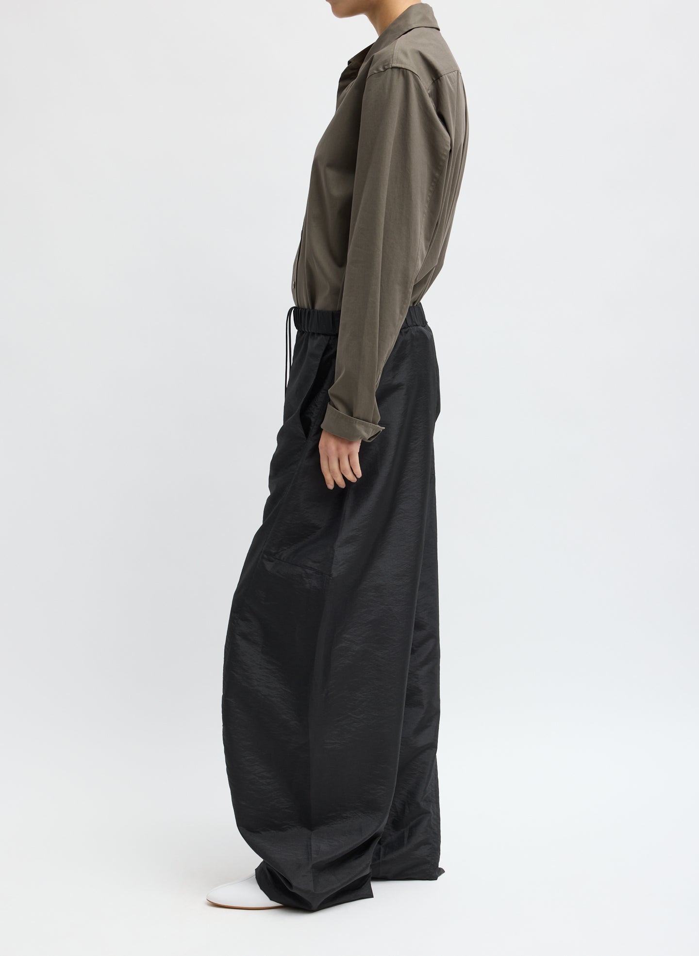 Black Crispy Nylon Winslow Pant - barrel leg pull on pant, side view on model