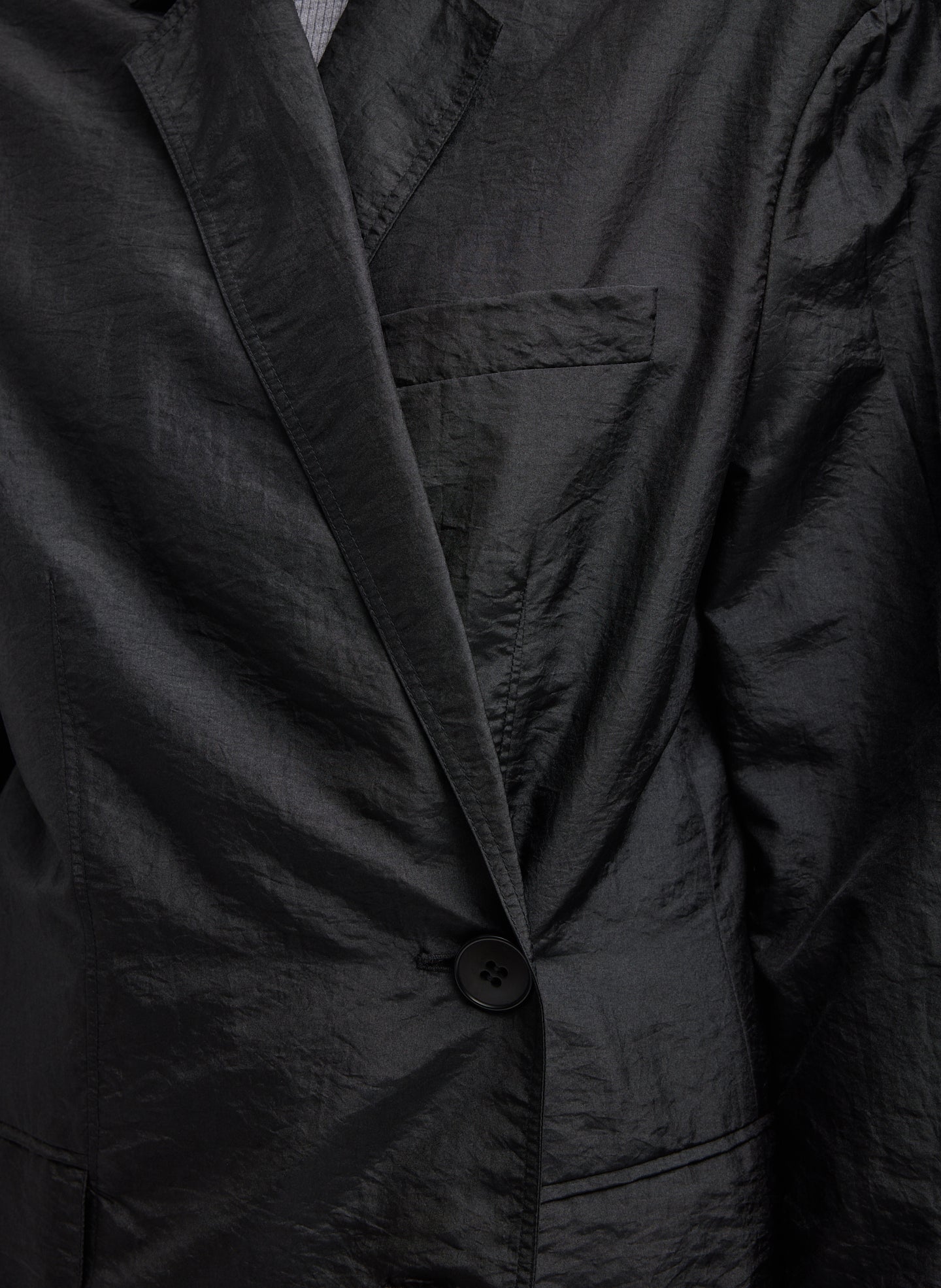 Black Crispy Nylon Liam Blazer -closeup of front button closure