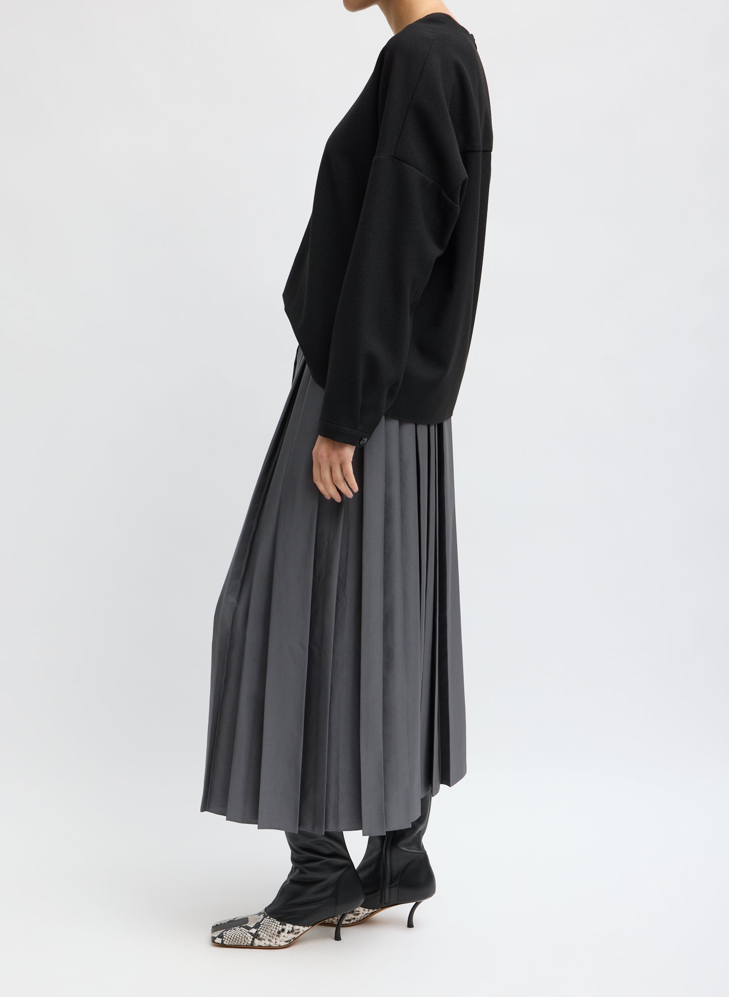 Grey Feather Weight Pleated Pull On Skirt - side view on model