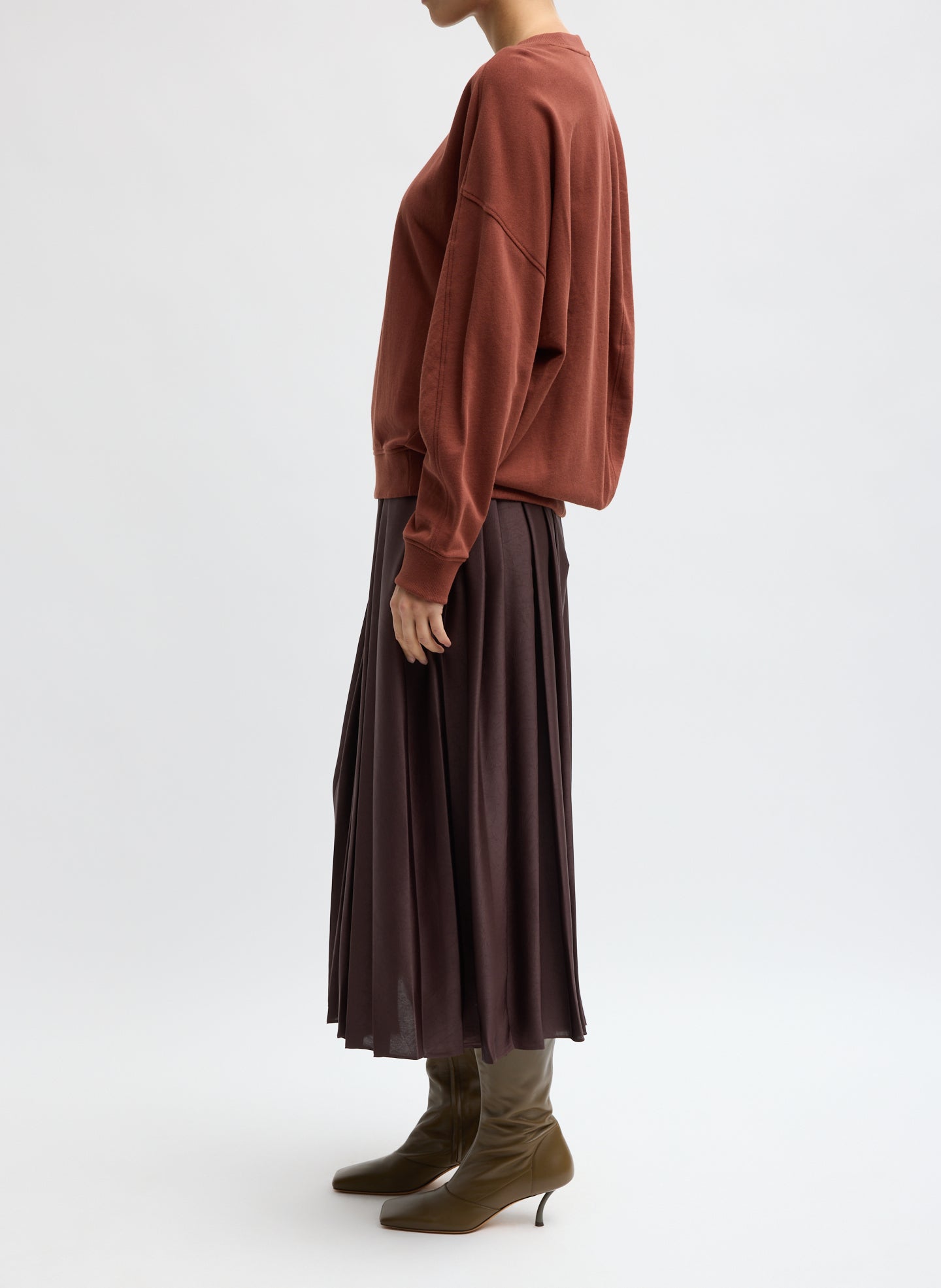Brown Feather Weight Pleated Pull On Skirt - side view on model