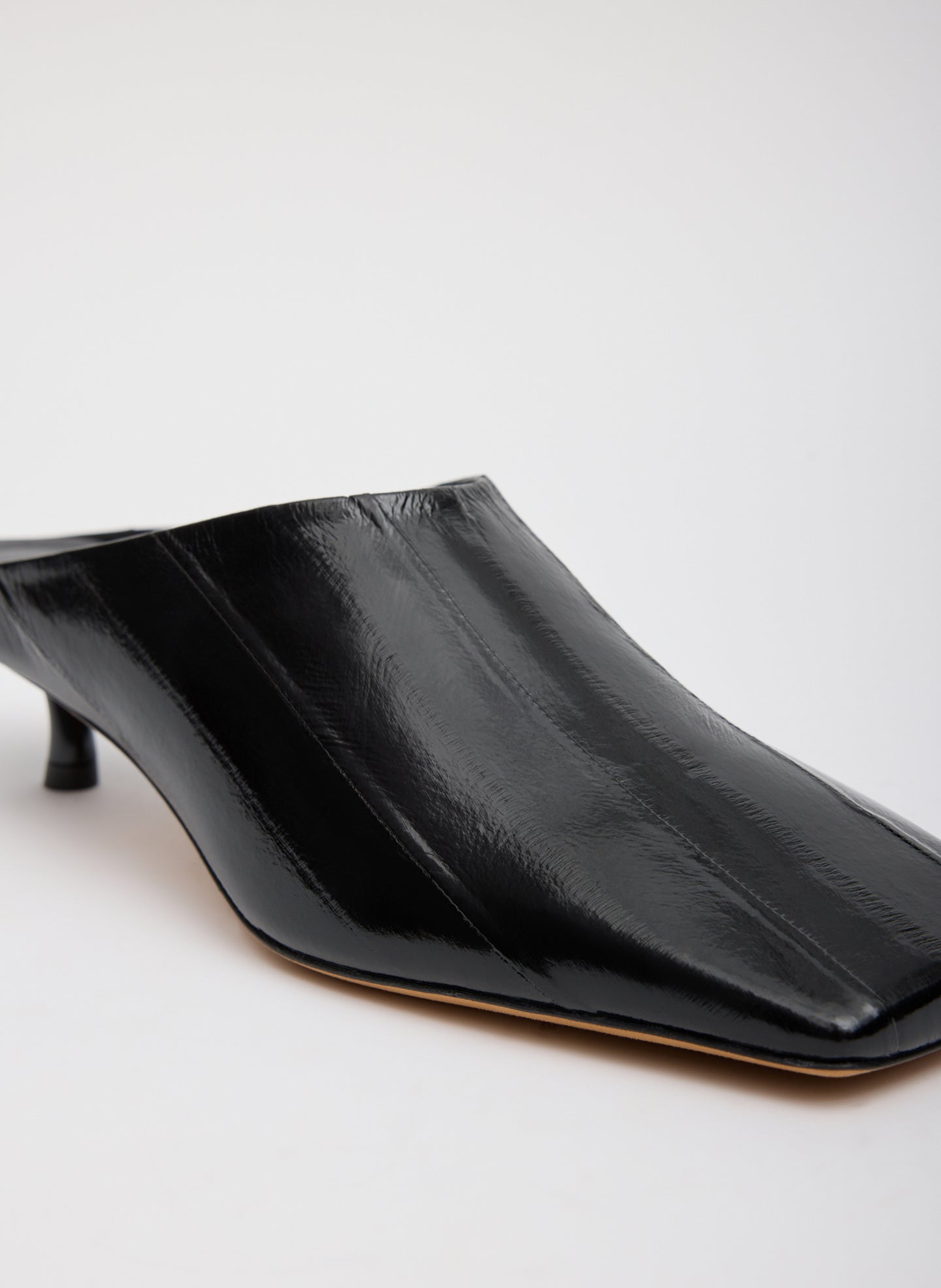Black Eel Skin Gwinnett Heeled Mules - closeup of eel skin fabrication