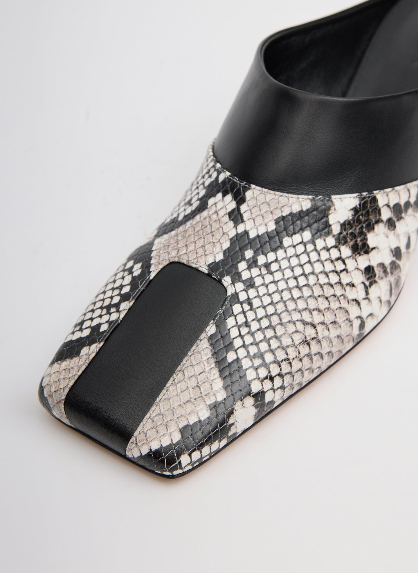 Two Tone Black and Snake Embossed Leather Gwinnett Heeled Mule - closeup of toe detail