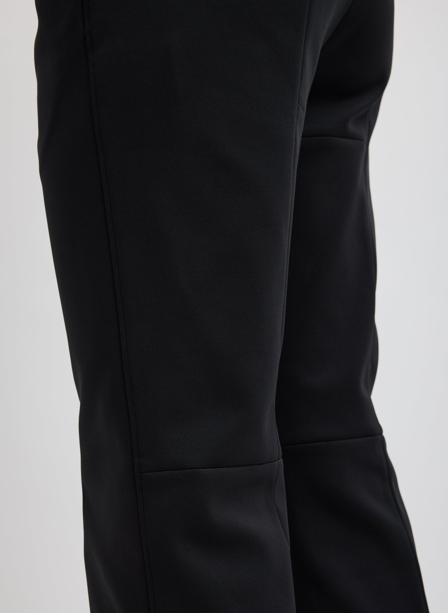 Black Compact Tech Knit Cropped Bootcut Pant - closeup of seam details