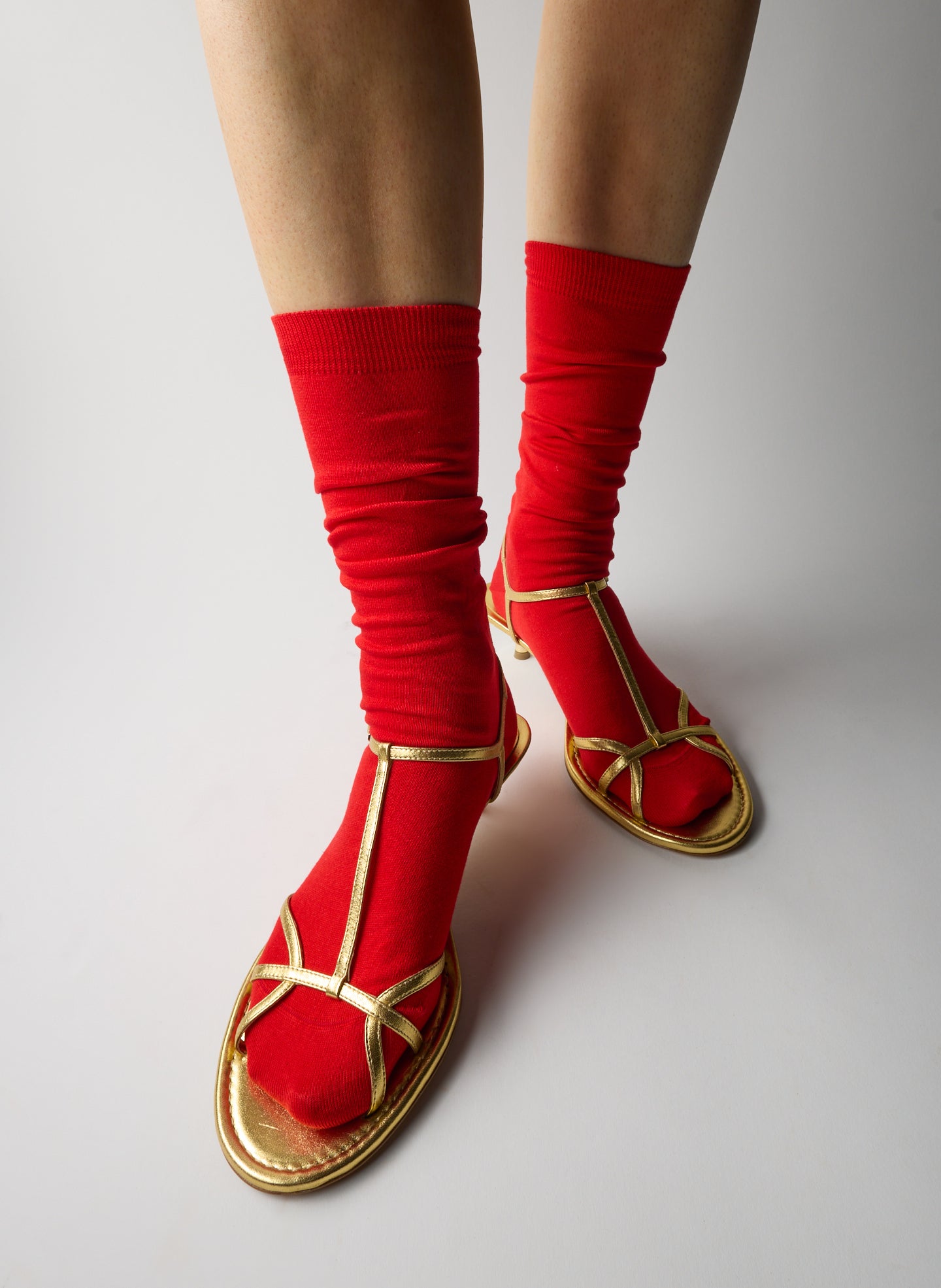 Gold Christopher Metallic Nappa Heel - heeled leather sandal, on model, styled with red socks