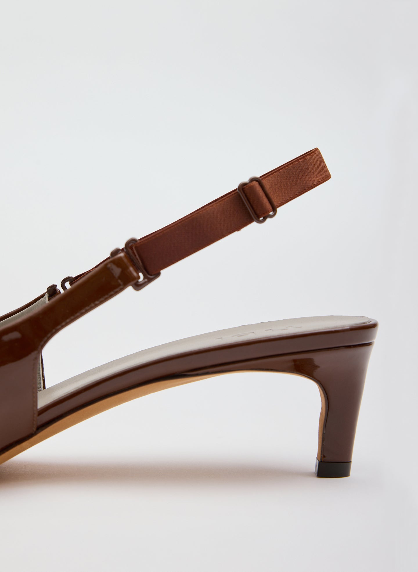 Dark Honey Patent Leather Gilbert Low Pump - closeup of back strap and heel detail