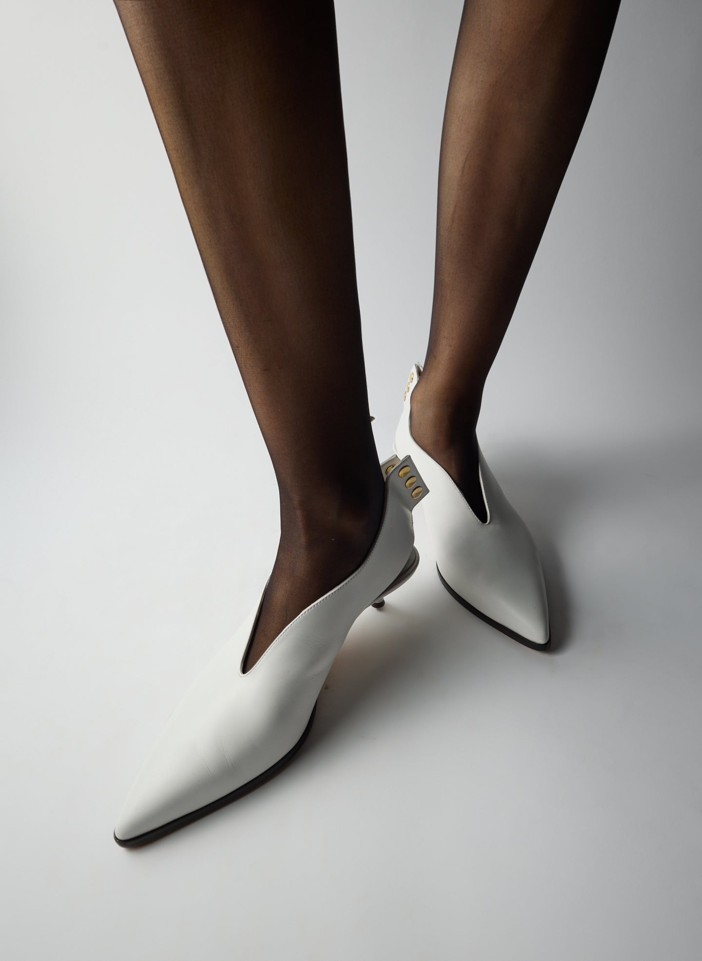 White Hans Bootie - heeled leather bootie, pointed toe, on model