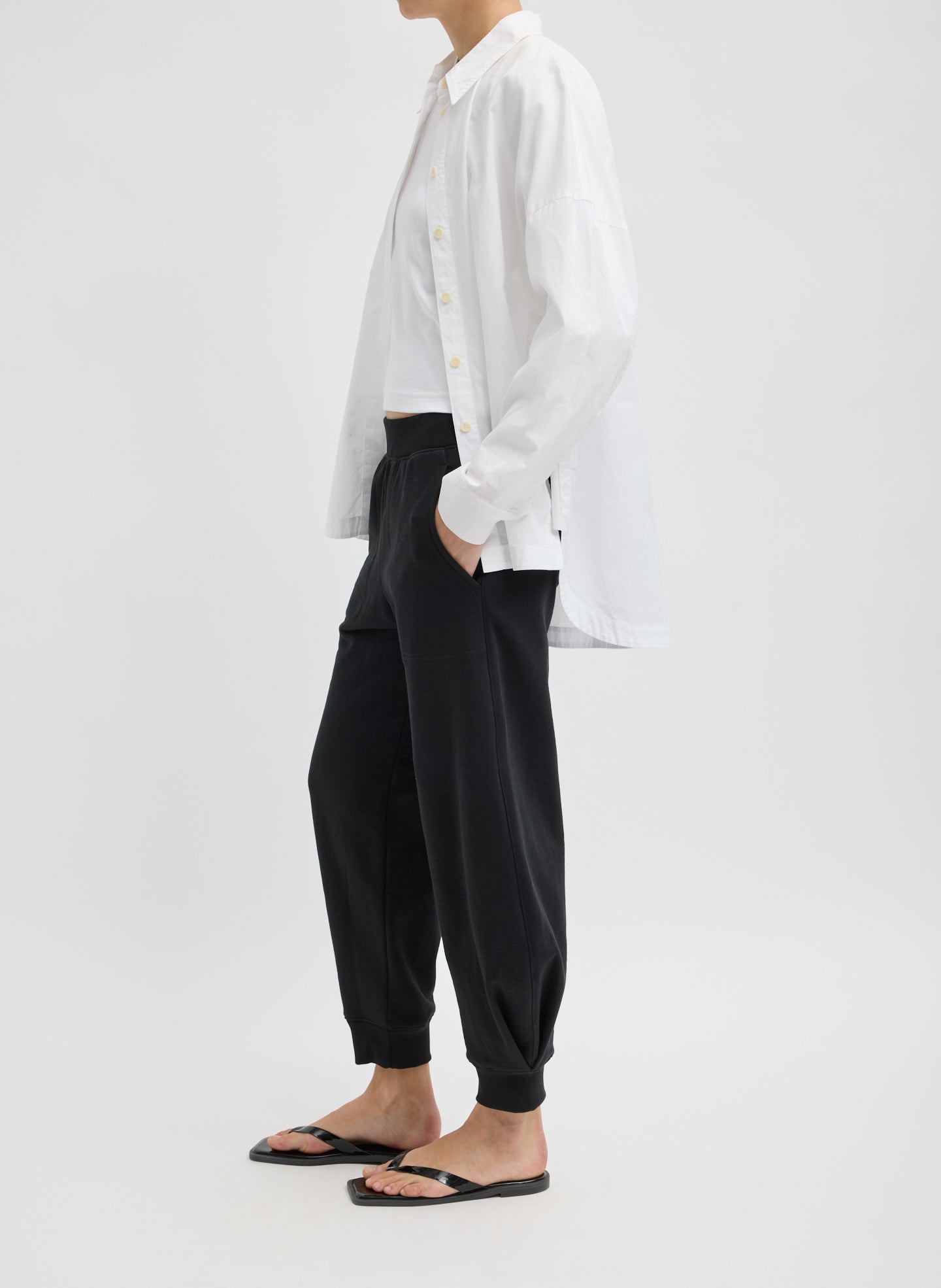 Black Calder Sweatpant - barrel leg sweatpant, side view on model