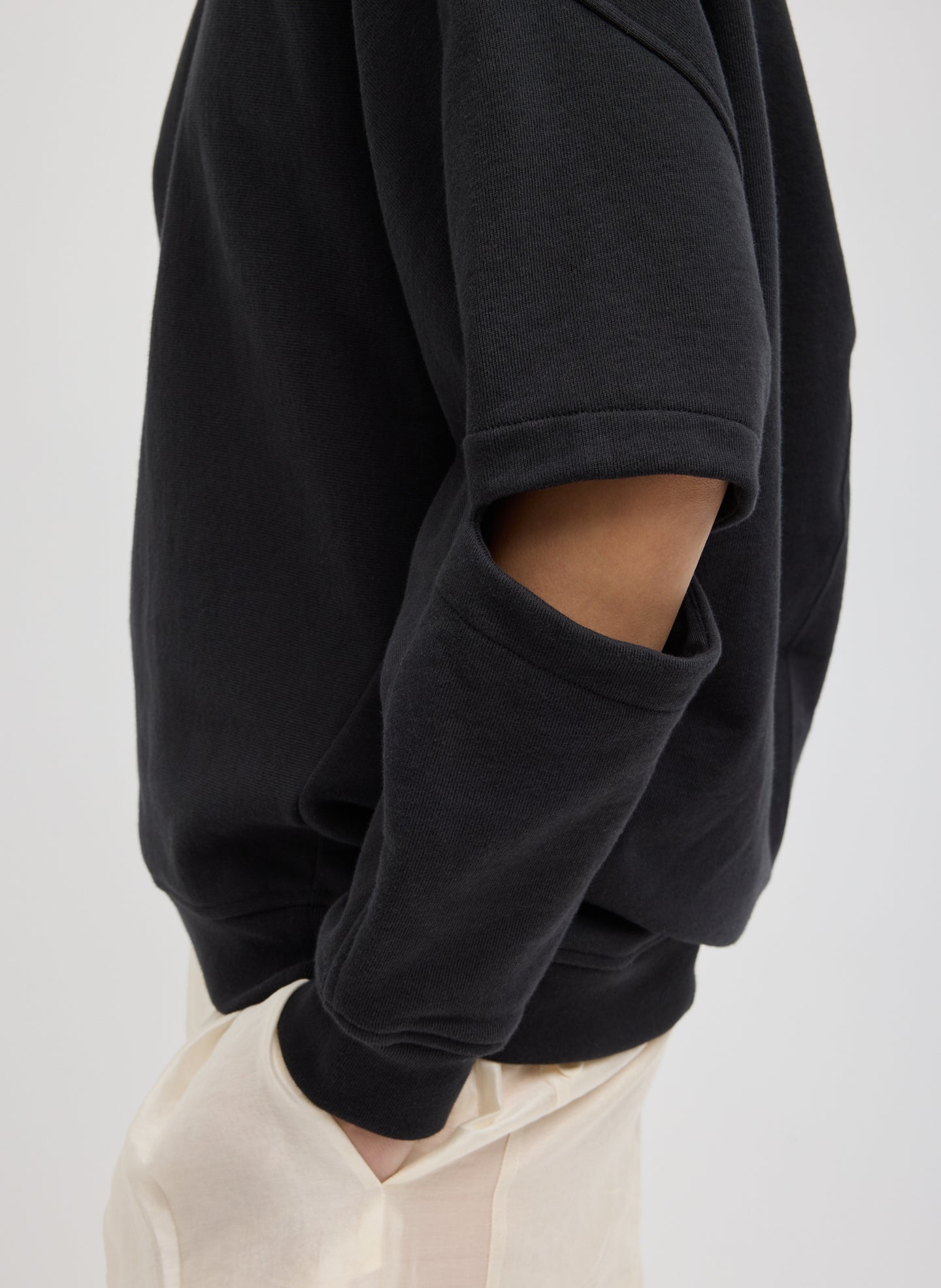 Black Cocoon Crewneck Sweatshirt - closeup of cutout detail at elbow