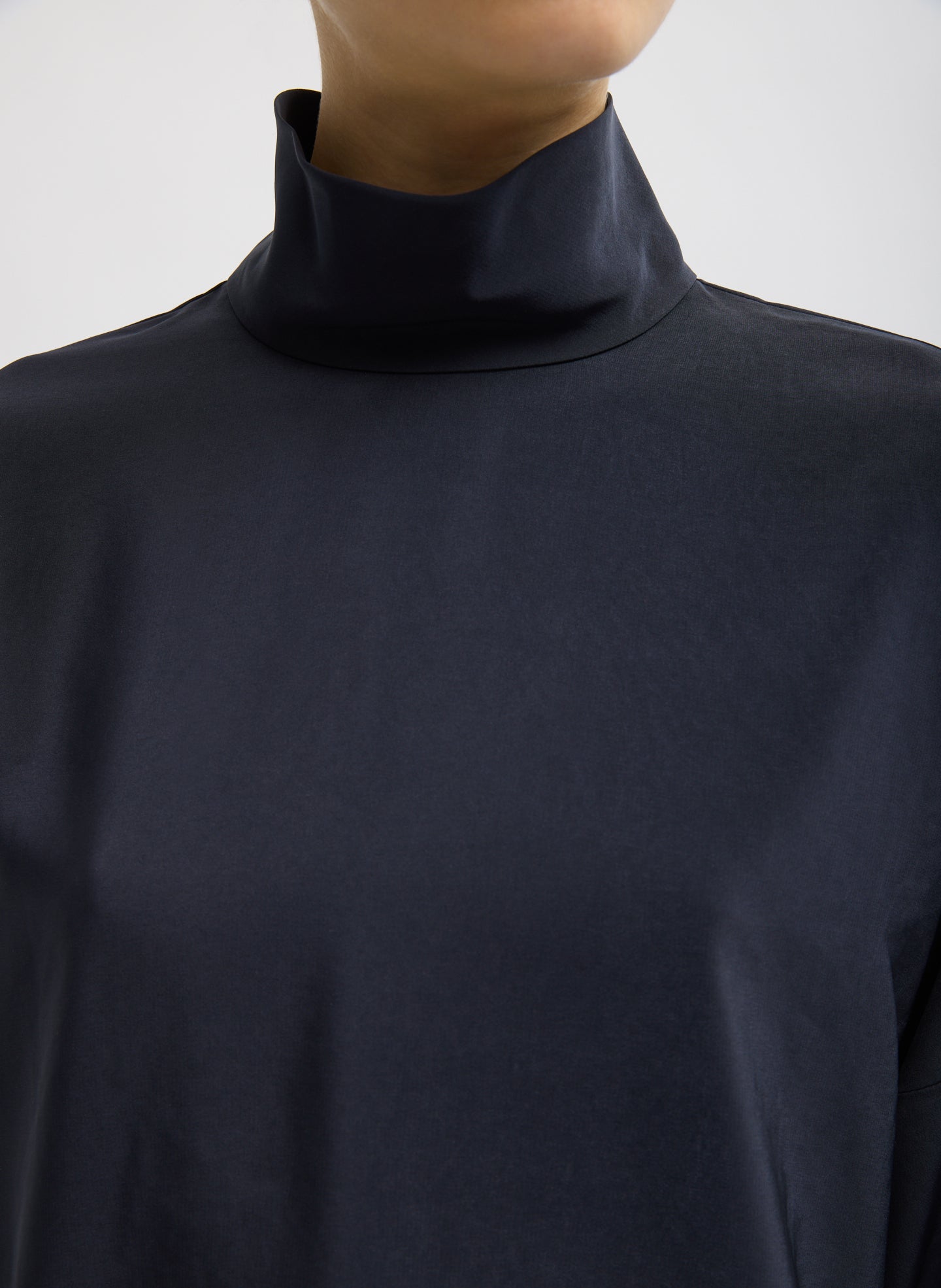 Navy Relaxed Suiting Funnel Neck Dolman Sleeve Top - closeup of high neck