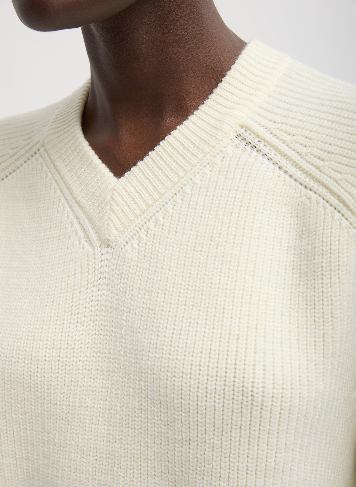 Ivory Cardigan Stitch V-Neck Easy Pullover - closeup of ribbed v-neck neckline