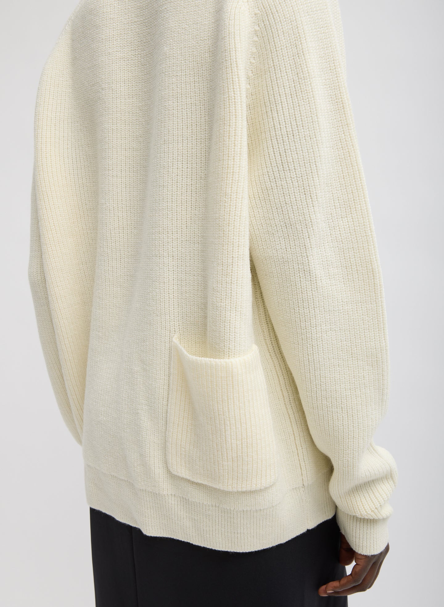 Ivory Cardigan Stitch V-Neck Easy Pullover - closeup of back pocket detail