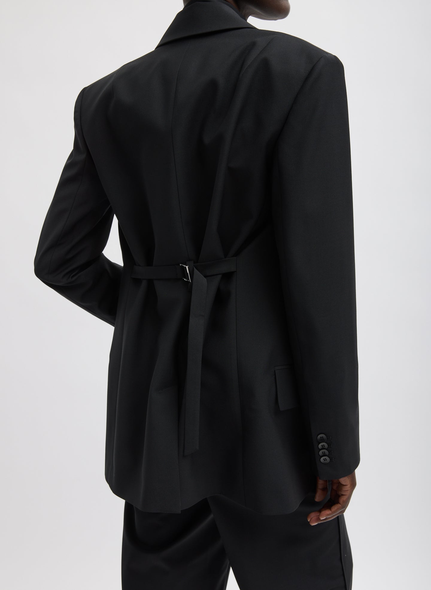 Black Recycled Tropical Wool Blazer With Back Belt - back belt, back view on model