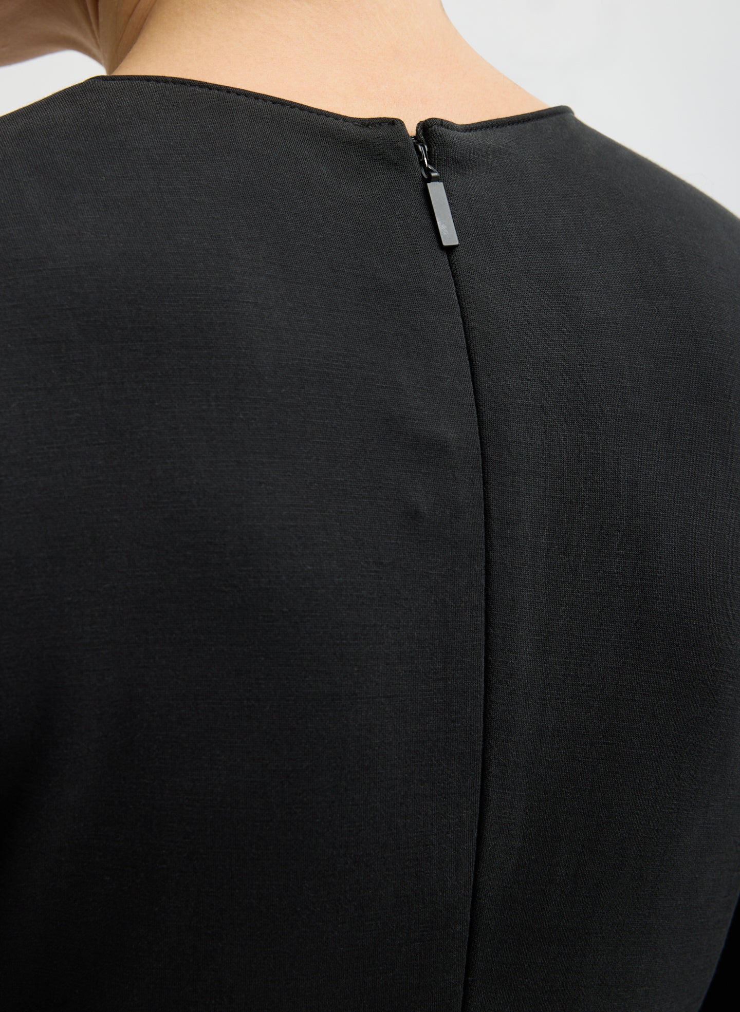 Black Feather Weight Viscose Neoprene Front Drape Dress - closeup of zip closure at back