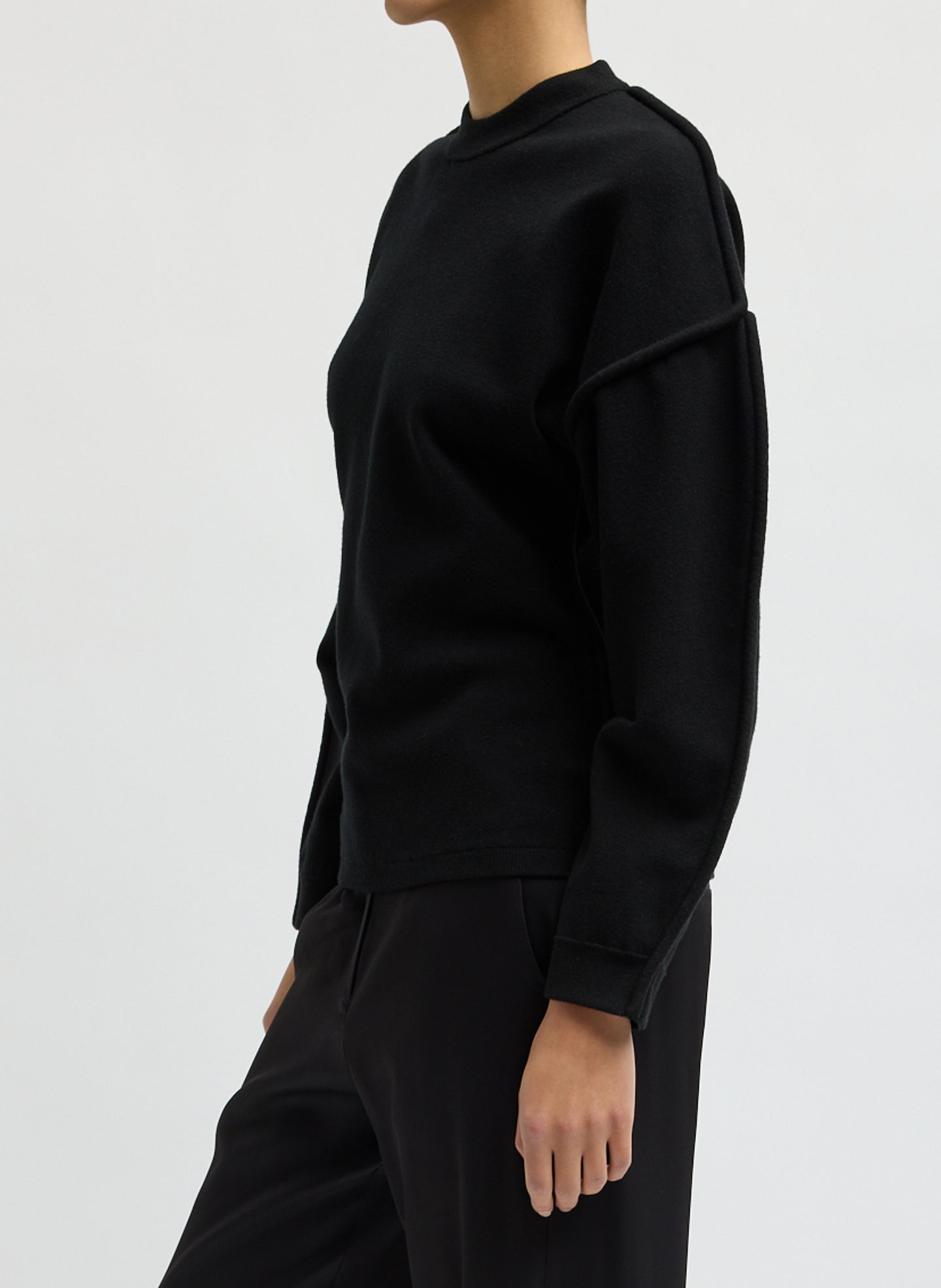 Black Sculpted Wool Fitted Sweater - side view on model