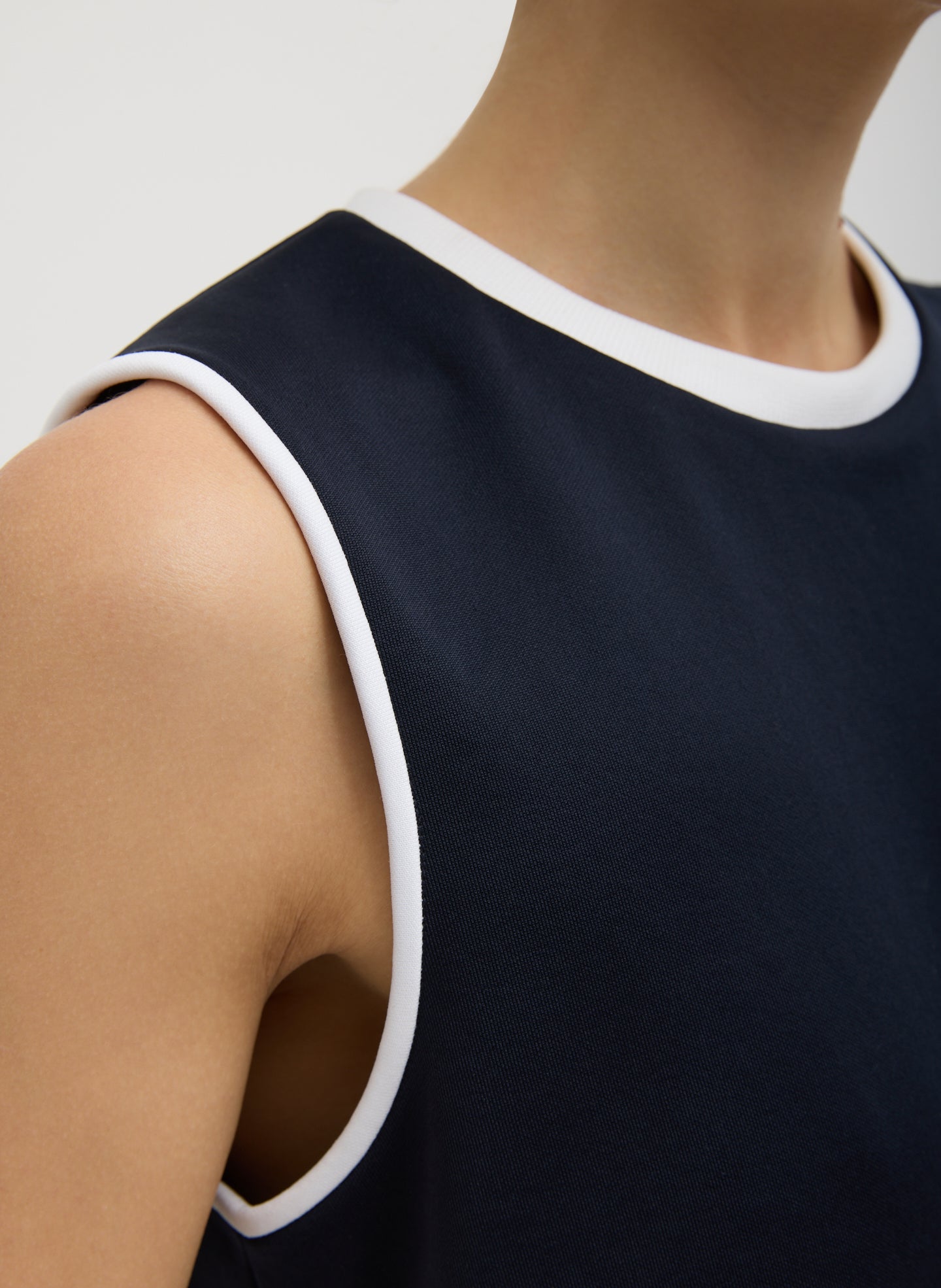 Navy Active Knit Flip Tank - closeup of white contrast trim