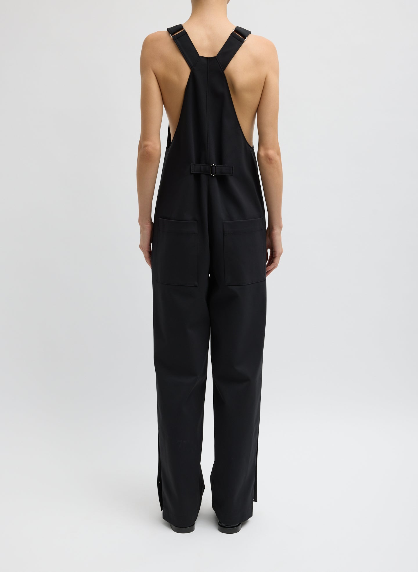 Black Compact Tech Knit Overalls - full look, back view on model