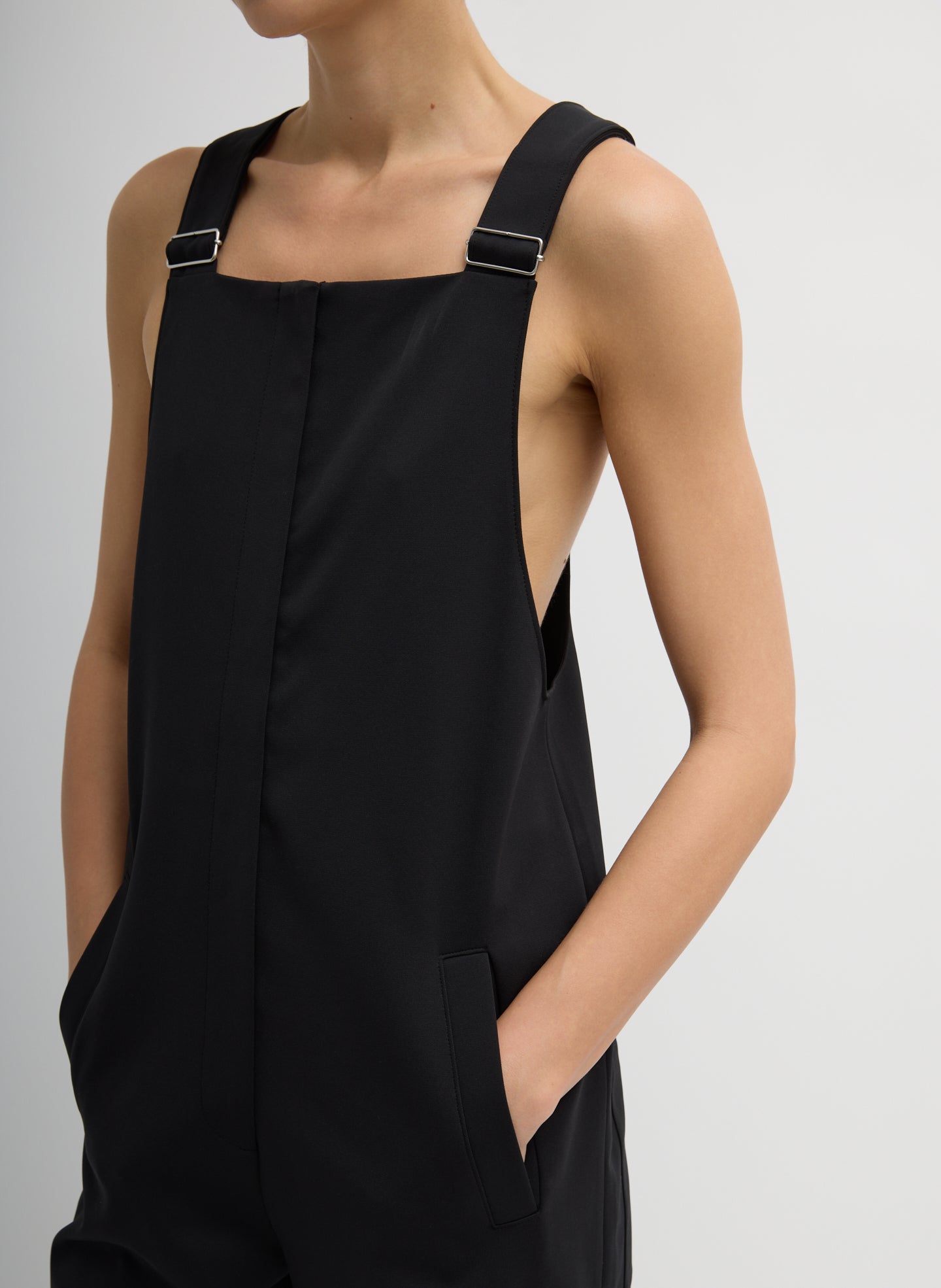Black Compact Tech Knit Overalls - closeup of adjustable strap details