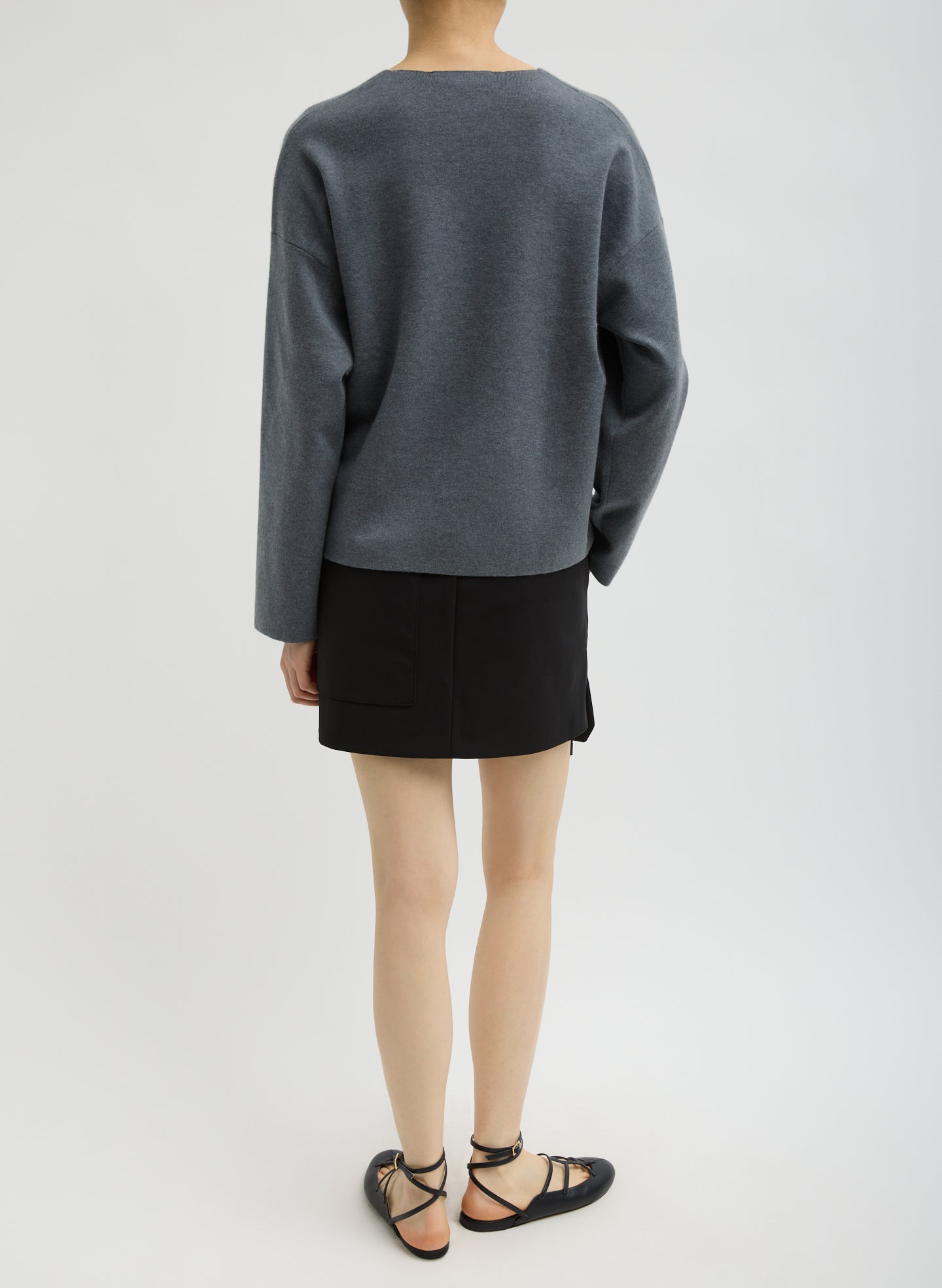 Black Compact Tech Knit Mini Skirt - full look, back view on model