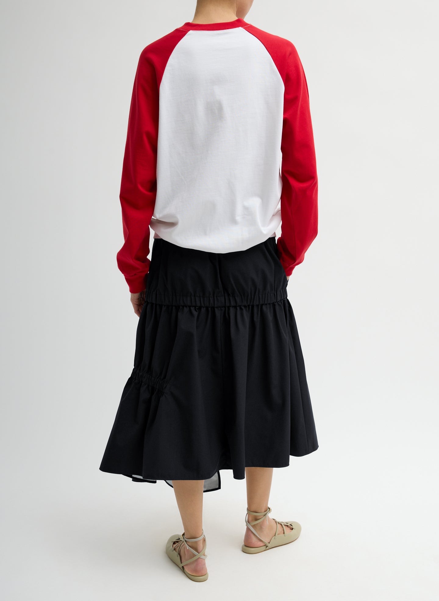 Black Tech Suiting Asymmetrical Skirt - zip up, back view on model