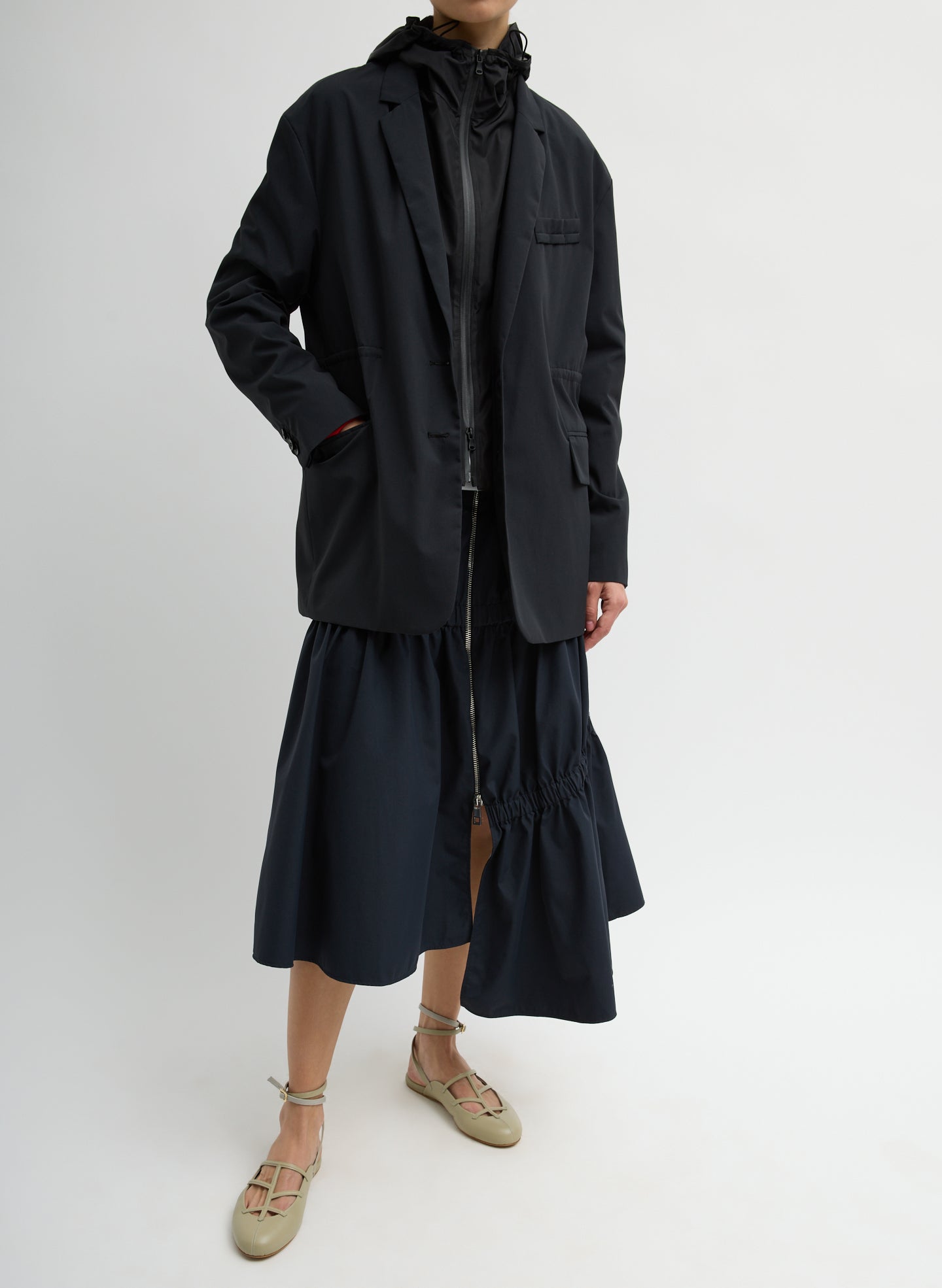 Black Tech Suiting Asymmetrical Skirt - zip up, front view on model