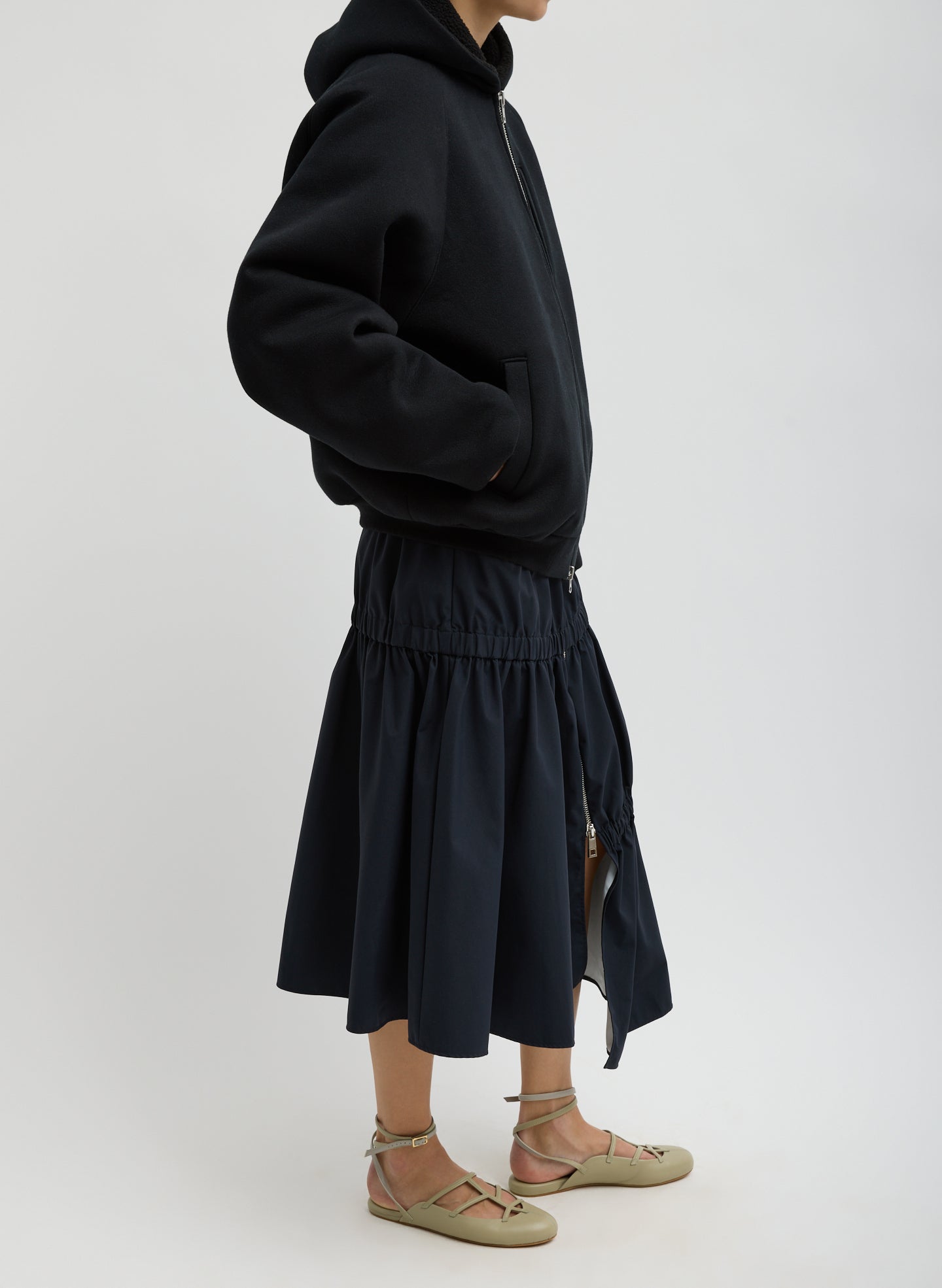 Black Tech Suiting Asymmetrical Skirt - zip up, side view on model