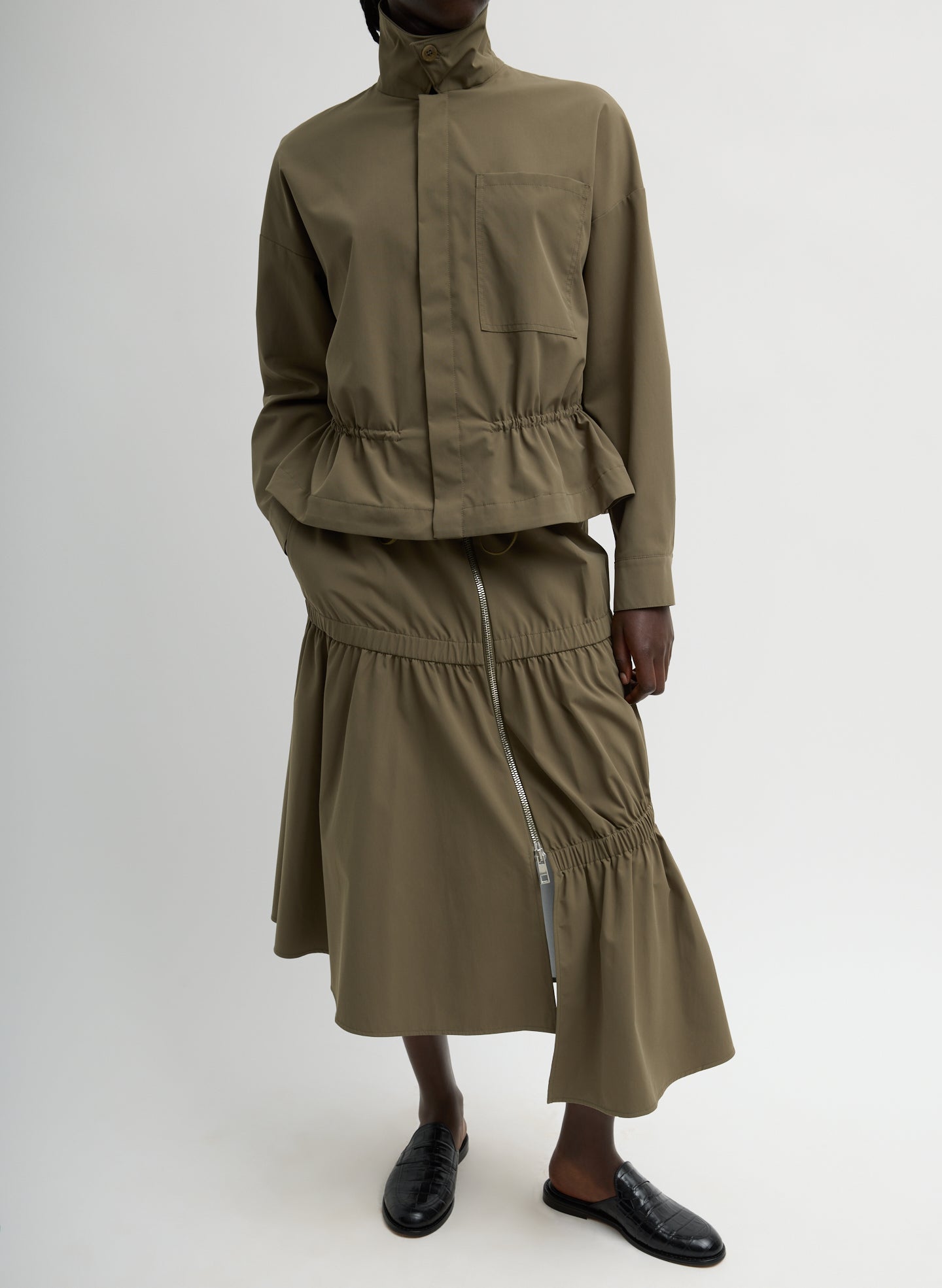 Dark Hazelnut Green Tech Suiting Asymmetrical Skirt - zip up, front view on model