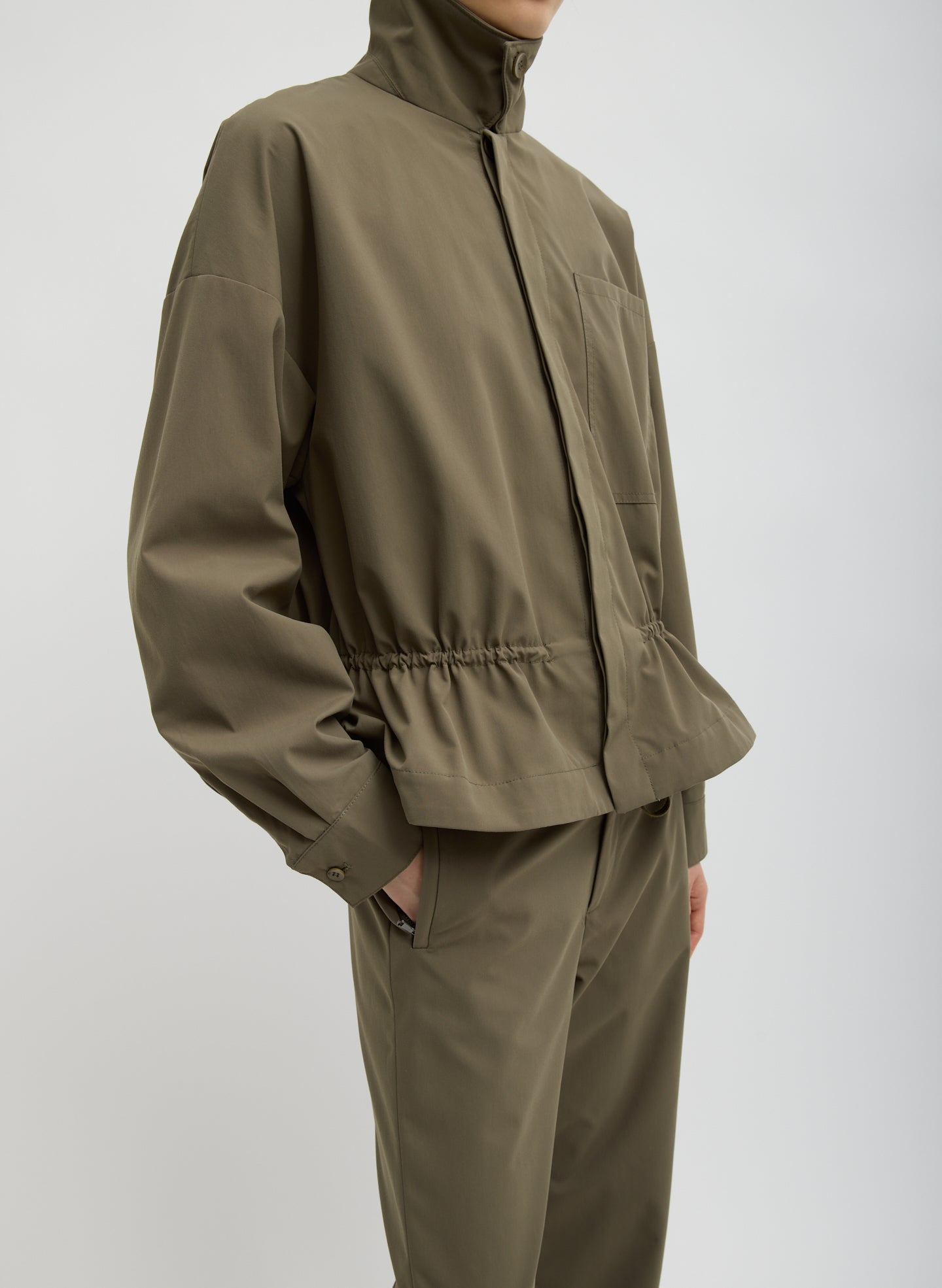 Dark Hazelnut Green Tech Suiting Anorak Bomber - side view on model