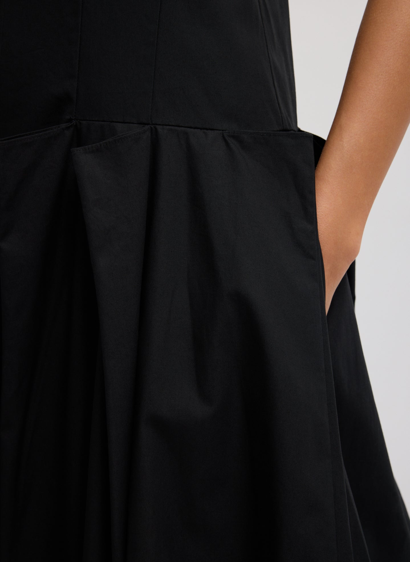 Black Compact Eco Poplin Pinched Pleat Dress - close up of side pocket and pleating details