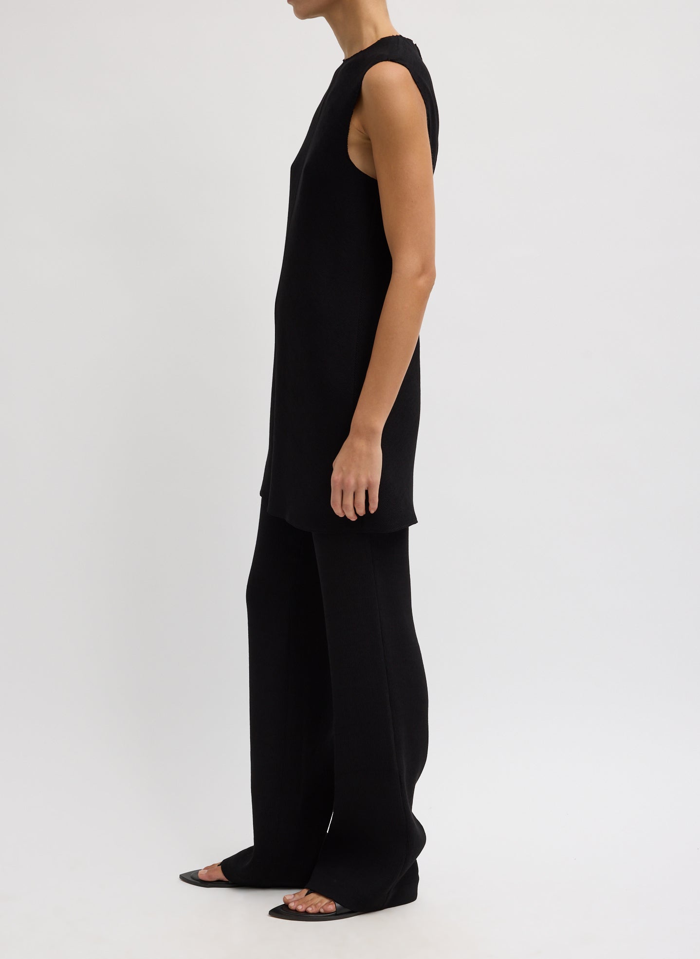 Black Viscose Plisse Sleeveless Bias Short Tunic - side view on model