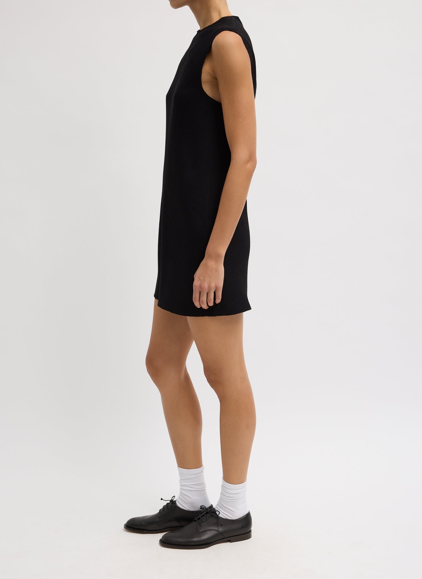 Black Viscose Plisse Sleeveless Bias Short Tunic - side view on model