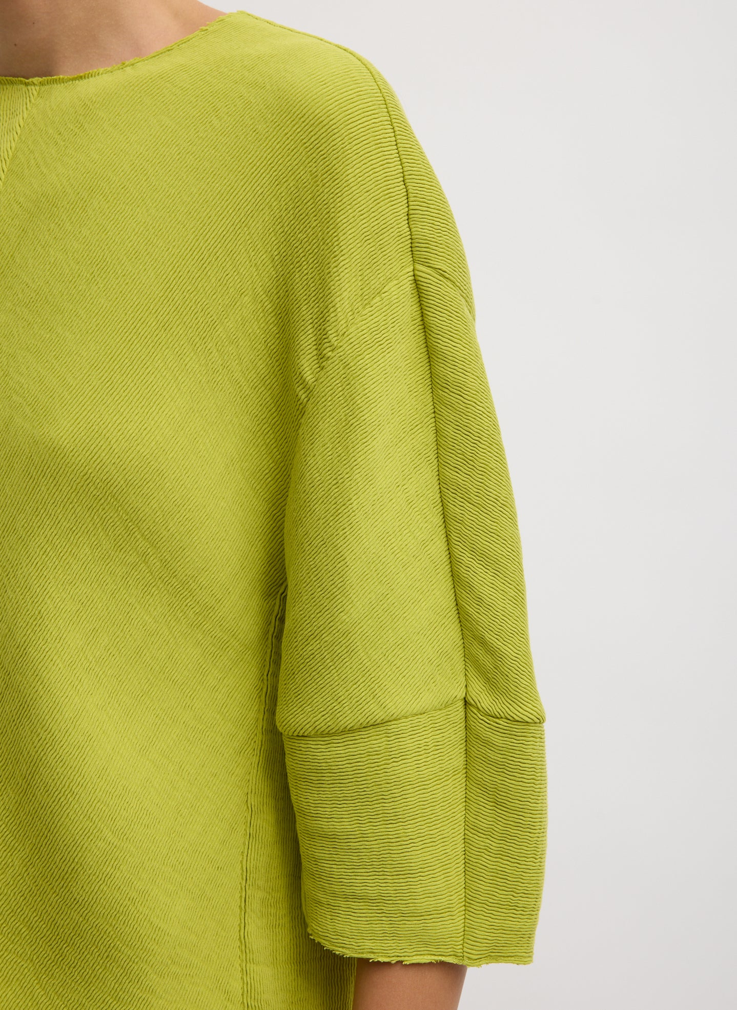 Chartreuse Viscose Plisse Hinged Short Sleeve Top - closeup of plisse fabrication