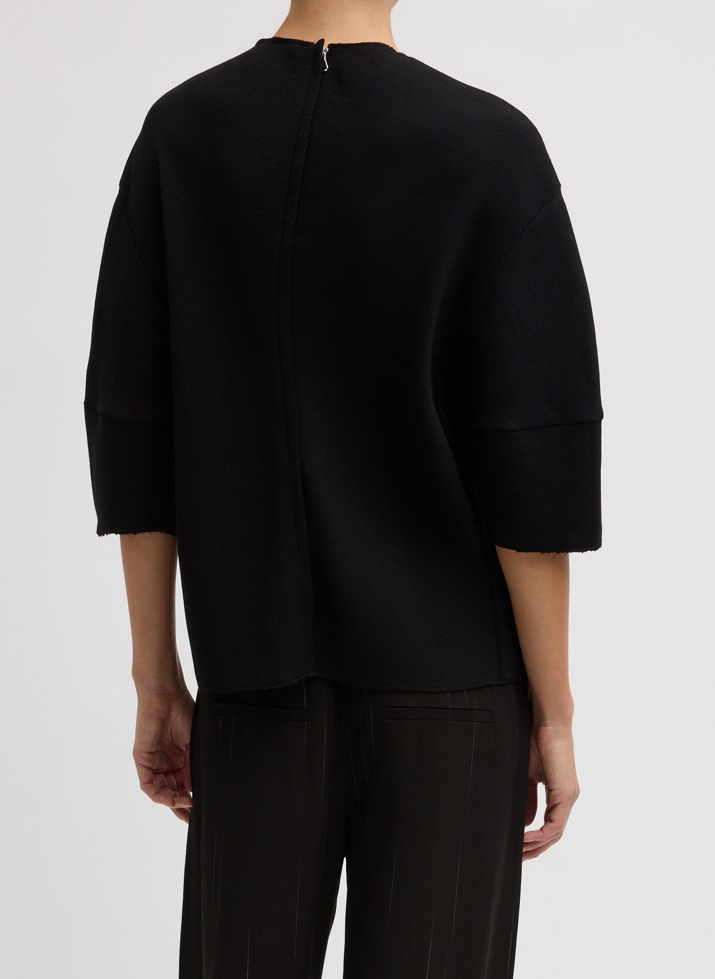 Black Viscose Plisse Hinged Short Sleeve Top - back view on model
