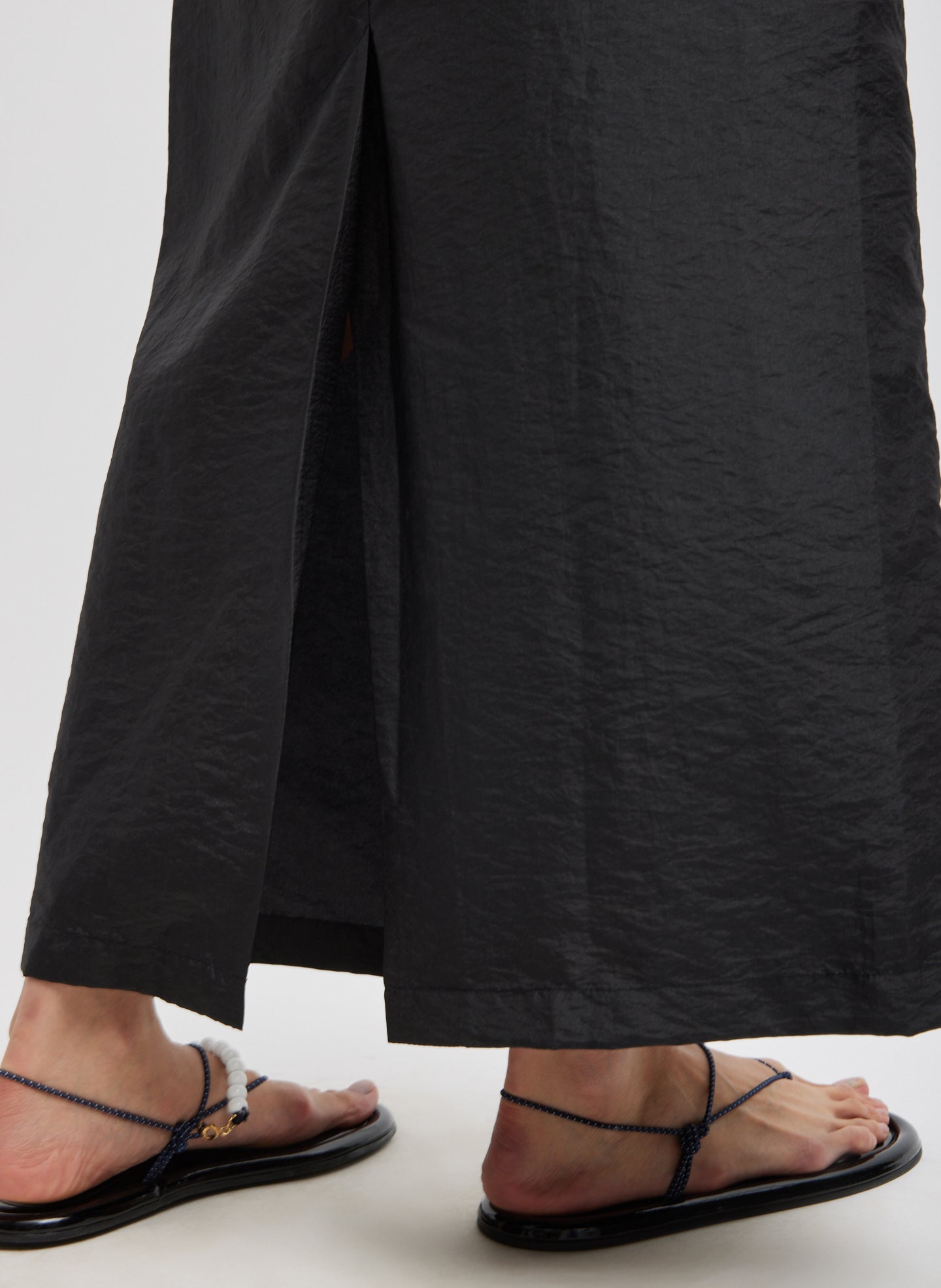 Black Crispy Nylon Maxi Skirt - closeup of vent detail at back