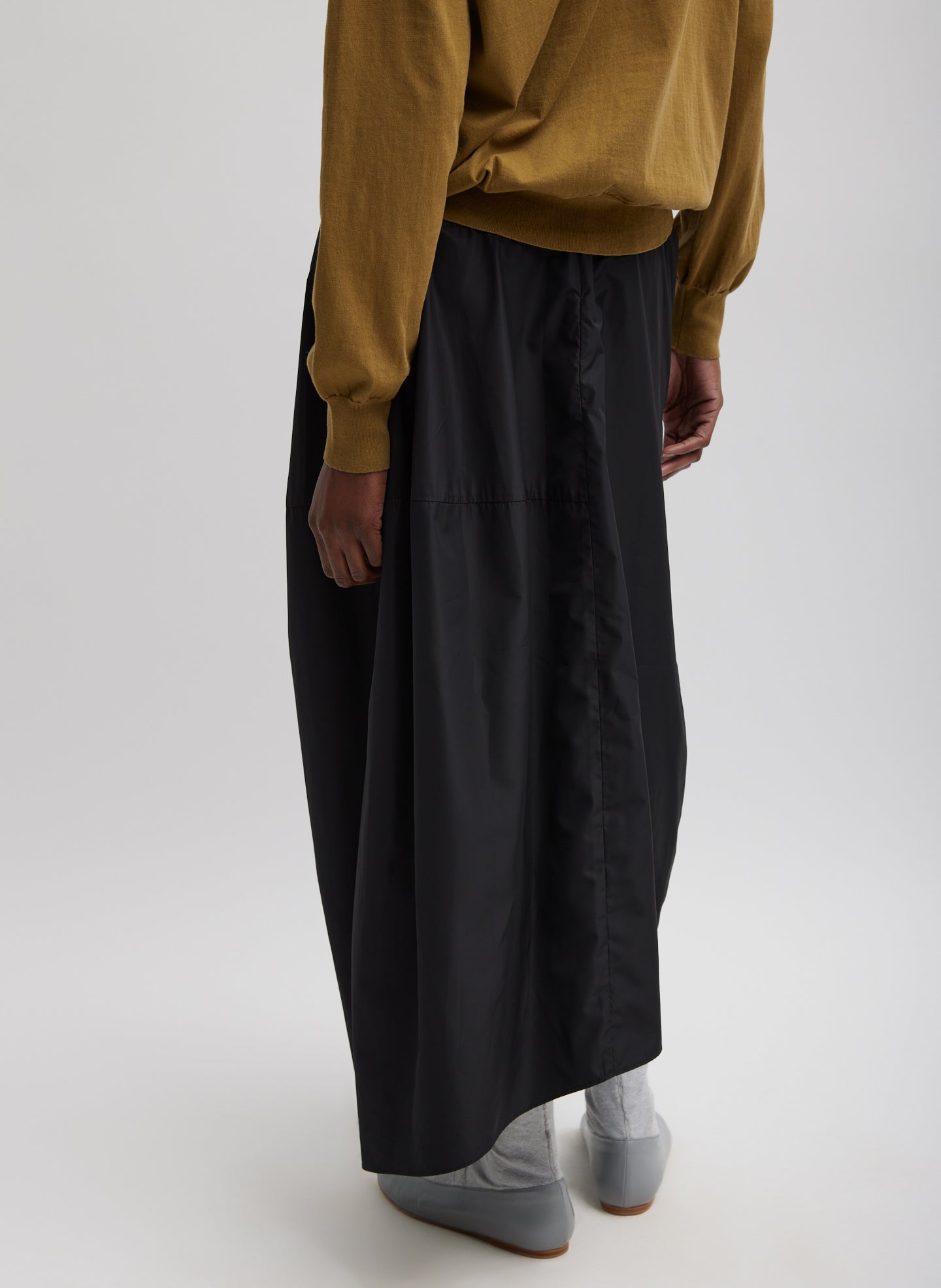 Black Nylon Asymmetrical Balloon Skirt - midi skirt, back view on model