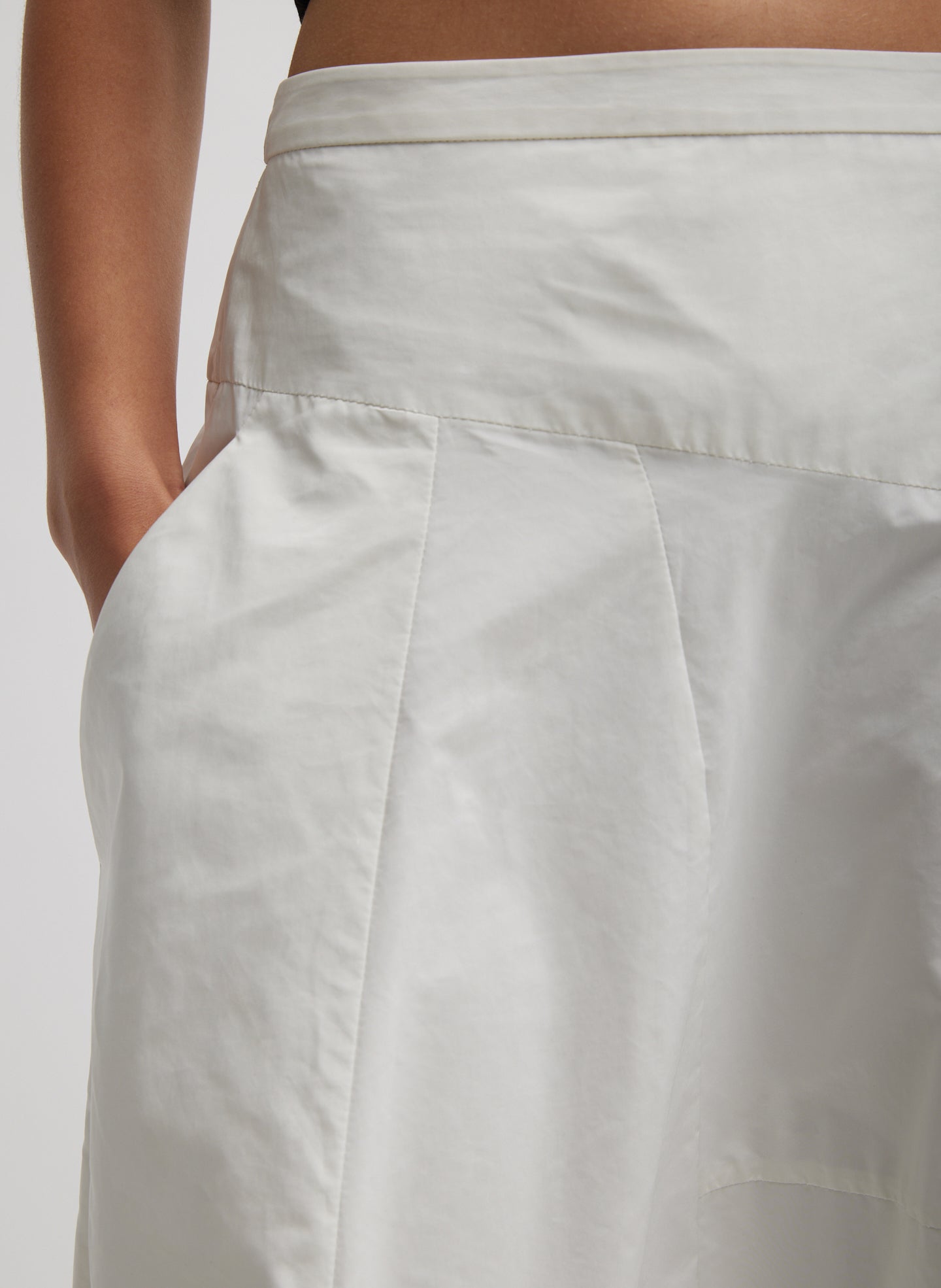 Off White Nylon Asymmetrical Balloon Skirt - closeup of side pocket and asymmetrical seam details