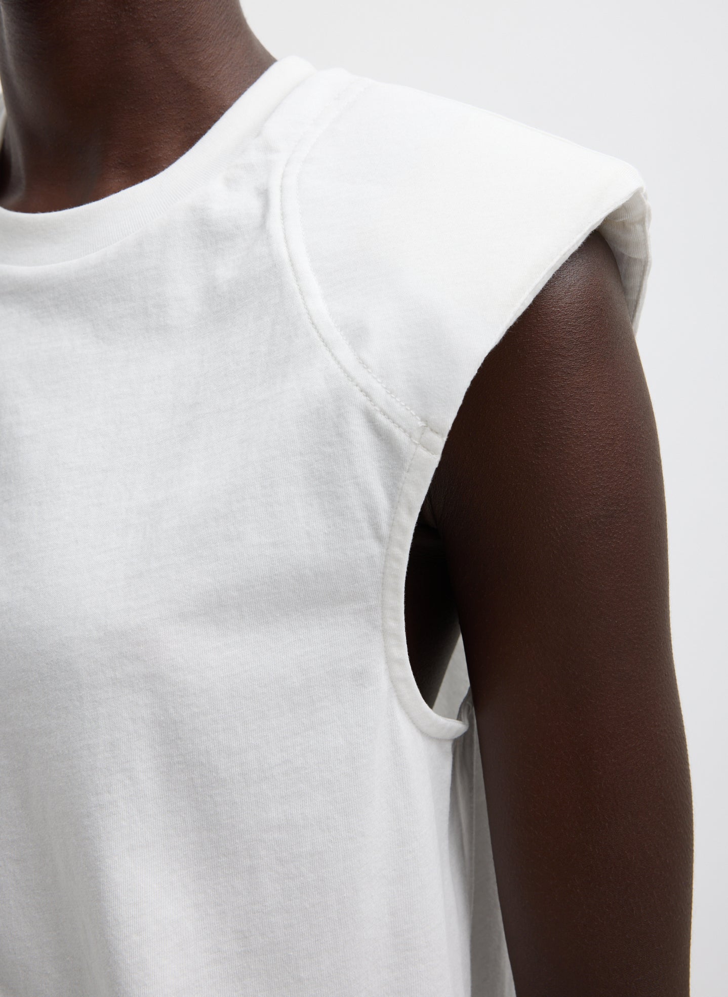 White T-Shirt Program Padded Shoulder Sleeveless Top - closeup of padded shoulder