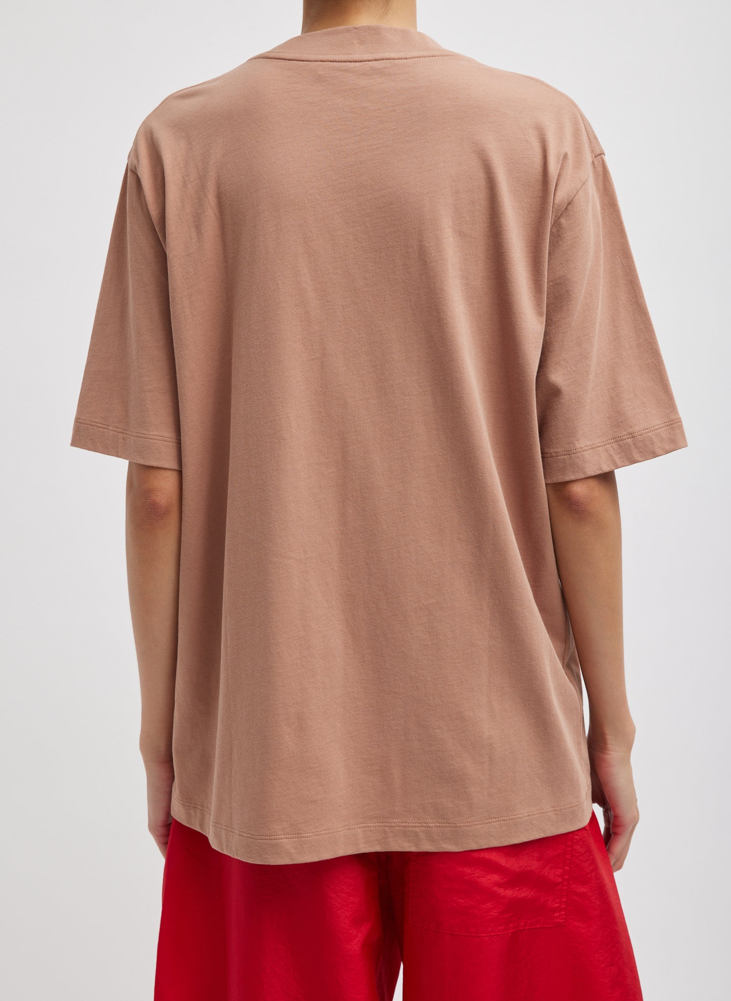 Butterscotch Orange Mock Neck Unisex T-Shirt - oversized fit, back view on model