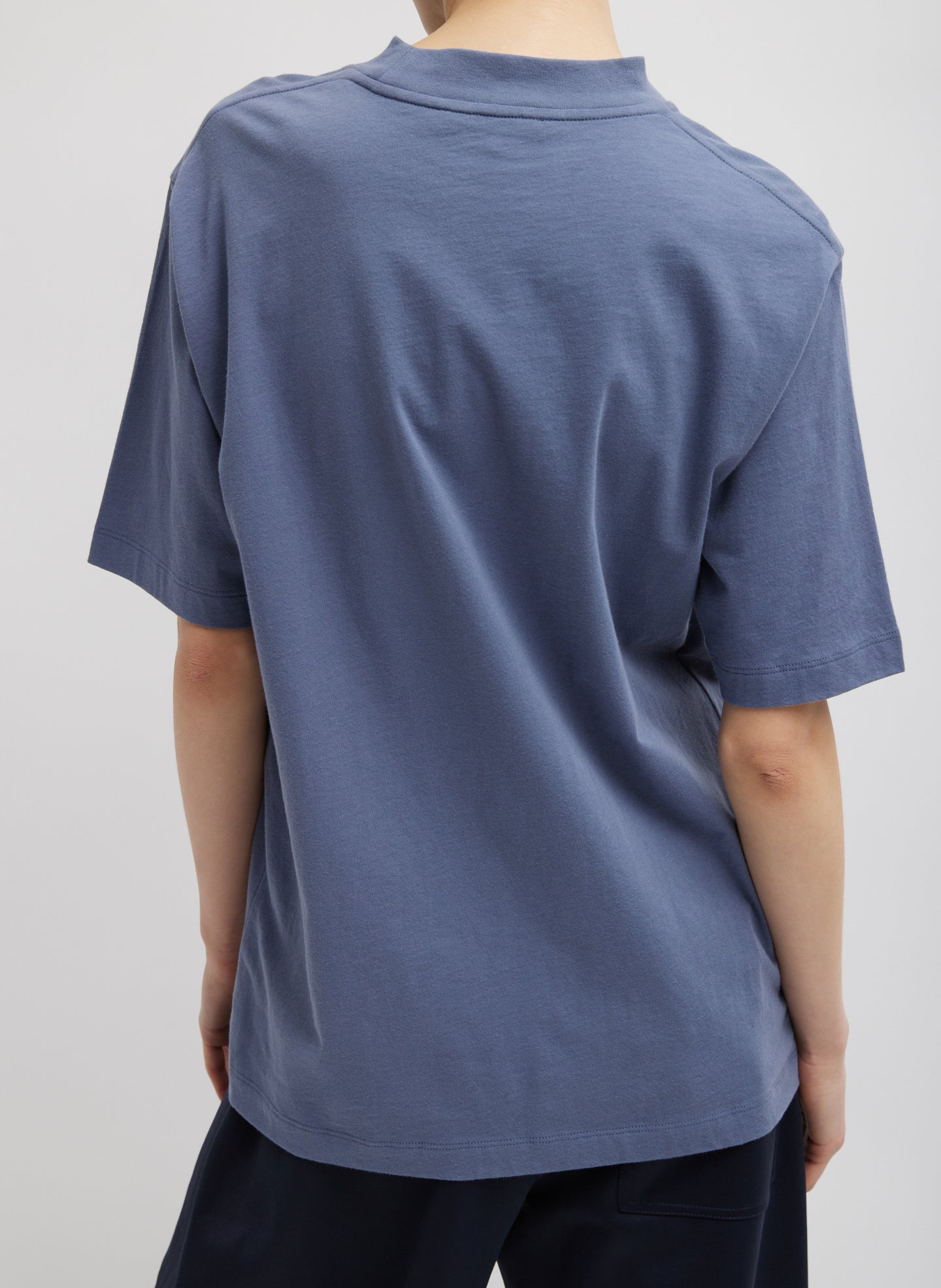 Dusty Navy Blue Mock Neck Unisex T-Shirt - oversized fit, back view on model