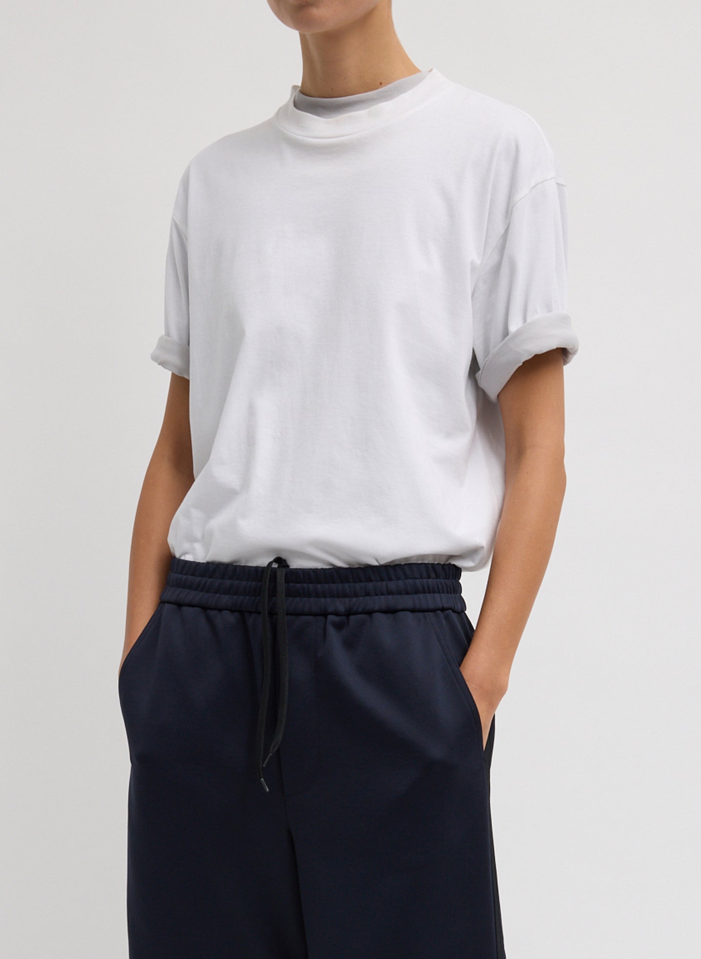 Mock Neck Unisex T-Shirt - White Mock Neck Unisex T-Shirt - oversized t-shirt, front view on model