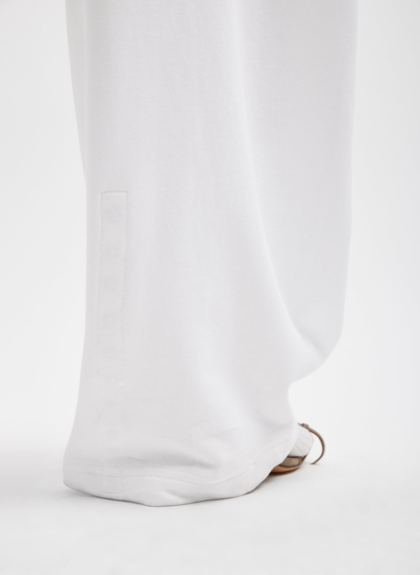 White Light Weight Sweatshirting Winslow Pant - closeup of hidden snap details at hem