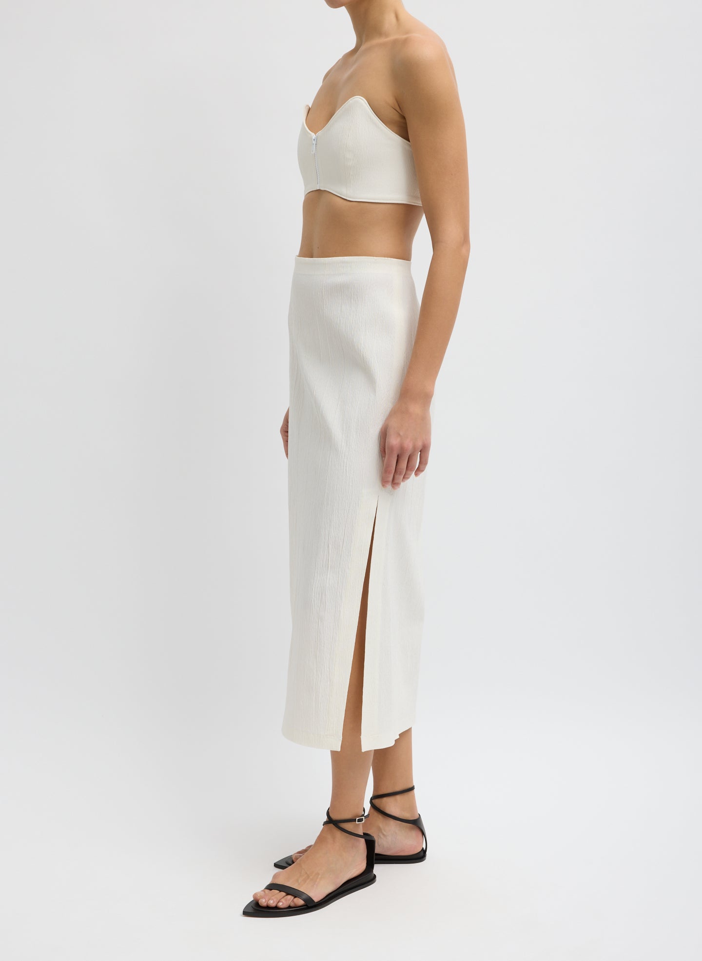 Ivory Creased Stretch Crepe Skirt - midi skirt with side slit, side view on model