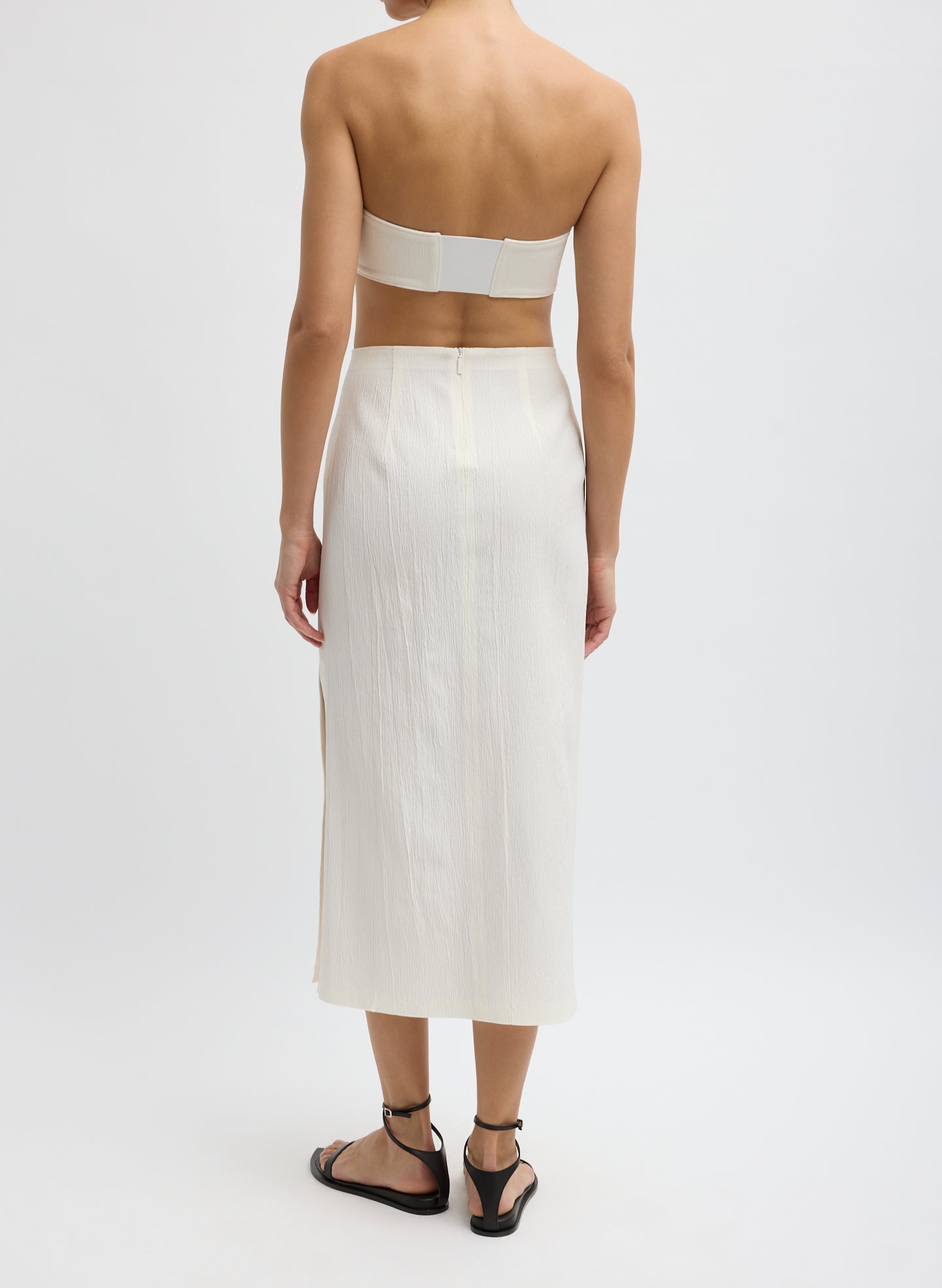 Ivory Creased Stretch Crepe Skirt - midi skirt with side slit, back view on model