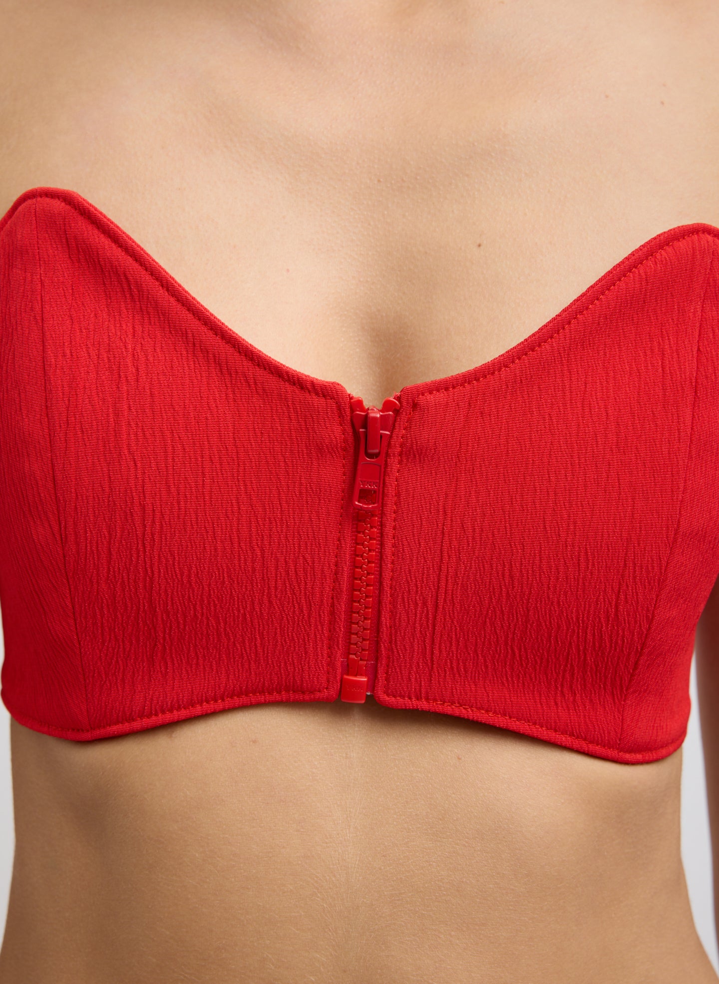 Red Creased Stretch Crepe Strapless Bralette - closeup of zip front detail