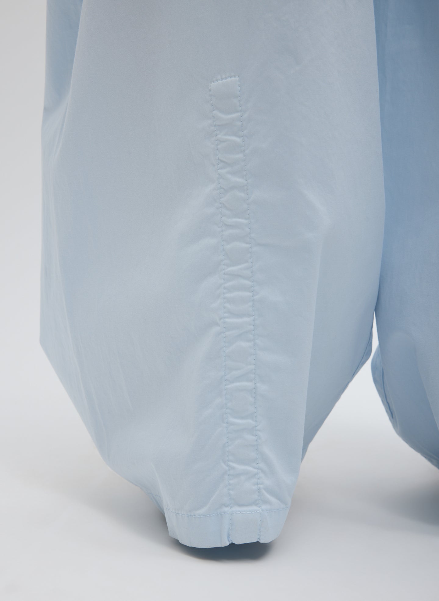 Pale Blue Garment Dyed Silky Cotton Winslow Pull On Pant - closeup of hidden snap details at hem
