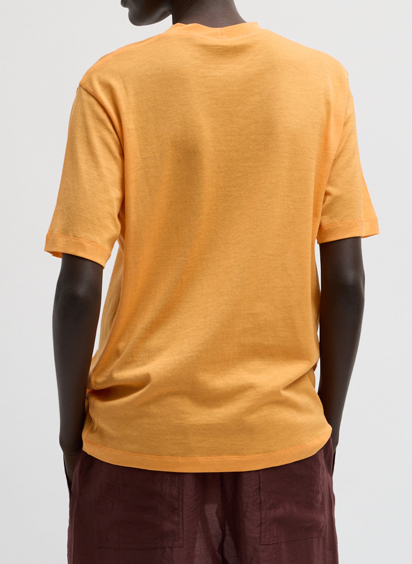 Orange Sheer Crepe Knit Mock Neck Unisex T-Shirt - back view on model