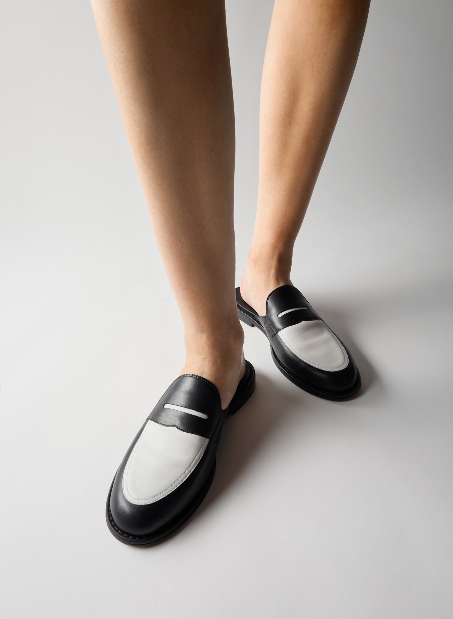 Black and White Herbert Slide - two-tone loafer slides on model